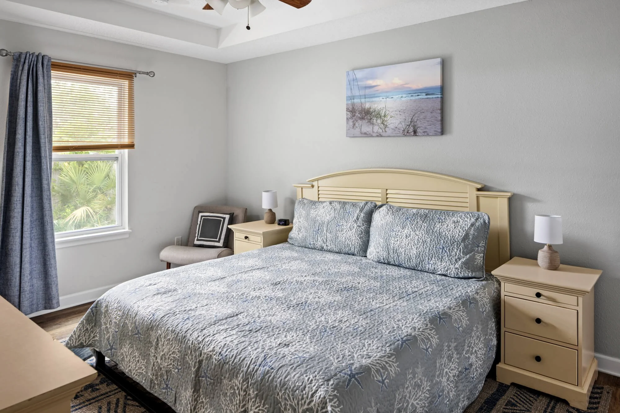King master bedroom with reading chair and window