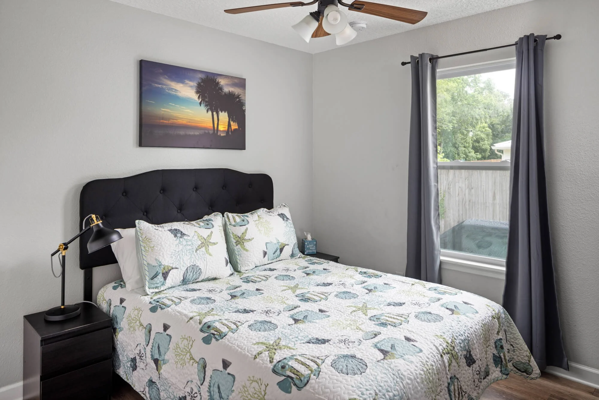 Second queen bedroom with coastal bedding and natural light