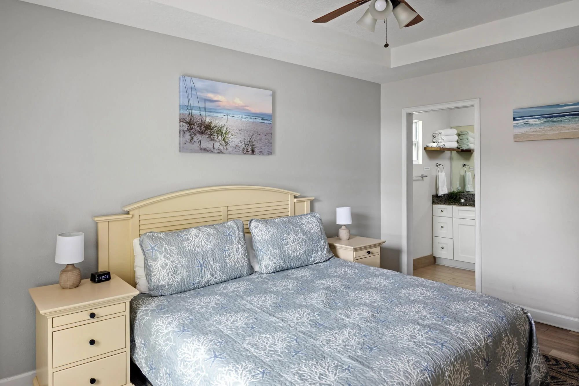 King master bedroom with coastal decor and ensuite bathroom