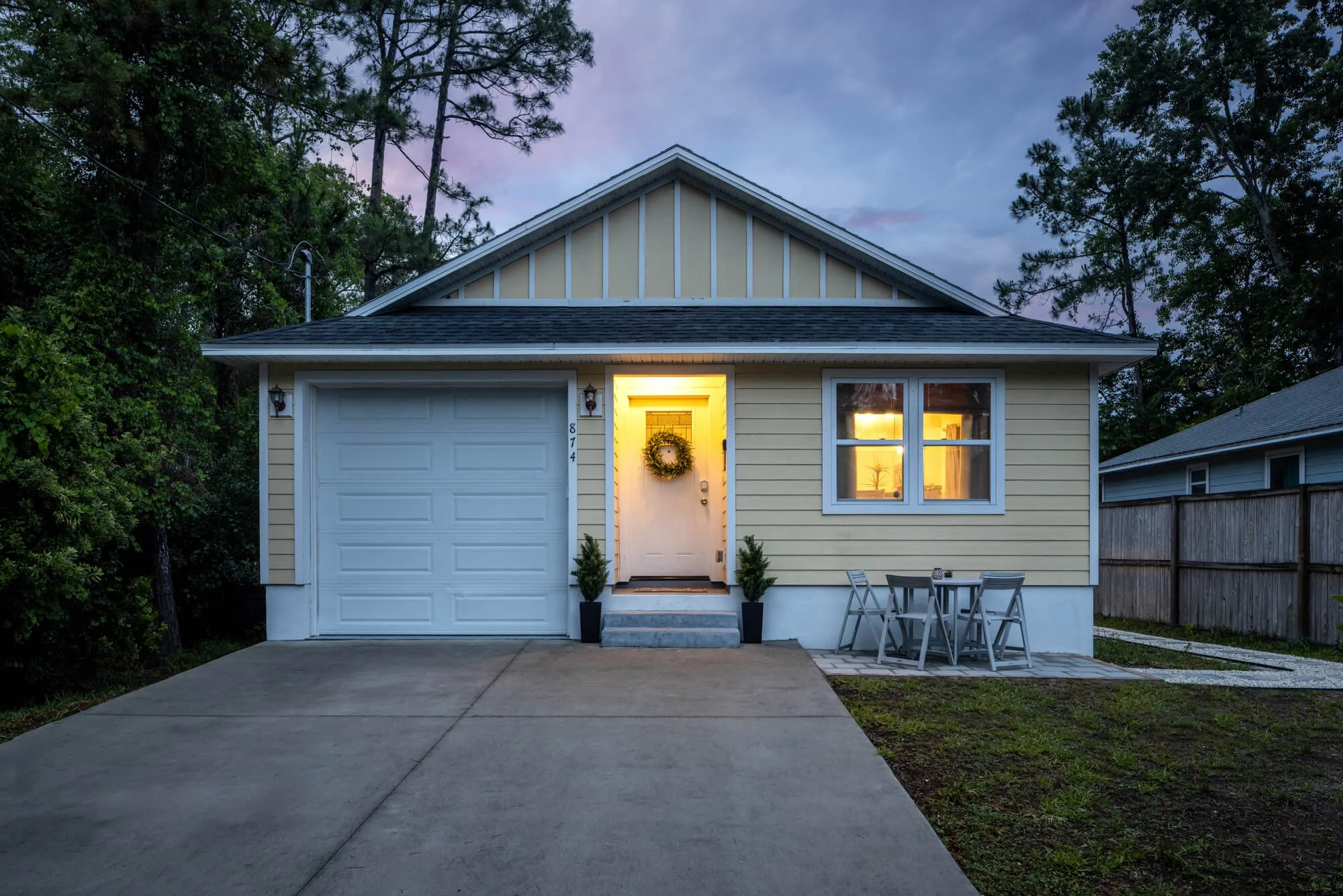 Front exterior of Collier Cove vacation rental in Saint Augustine at twilight with lit entry