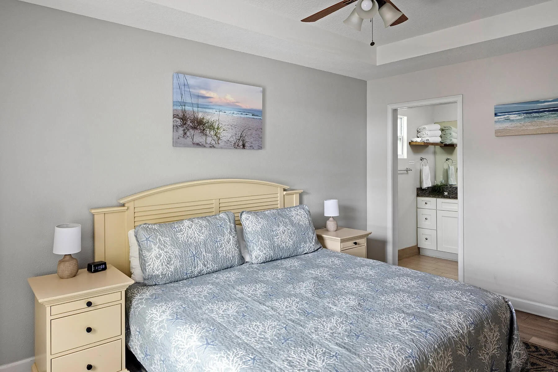 King master bedroom with coastal decor and ensuite bathroom