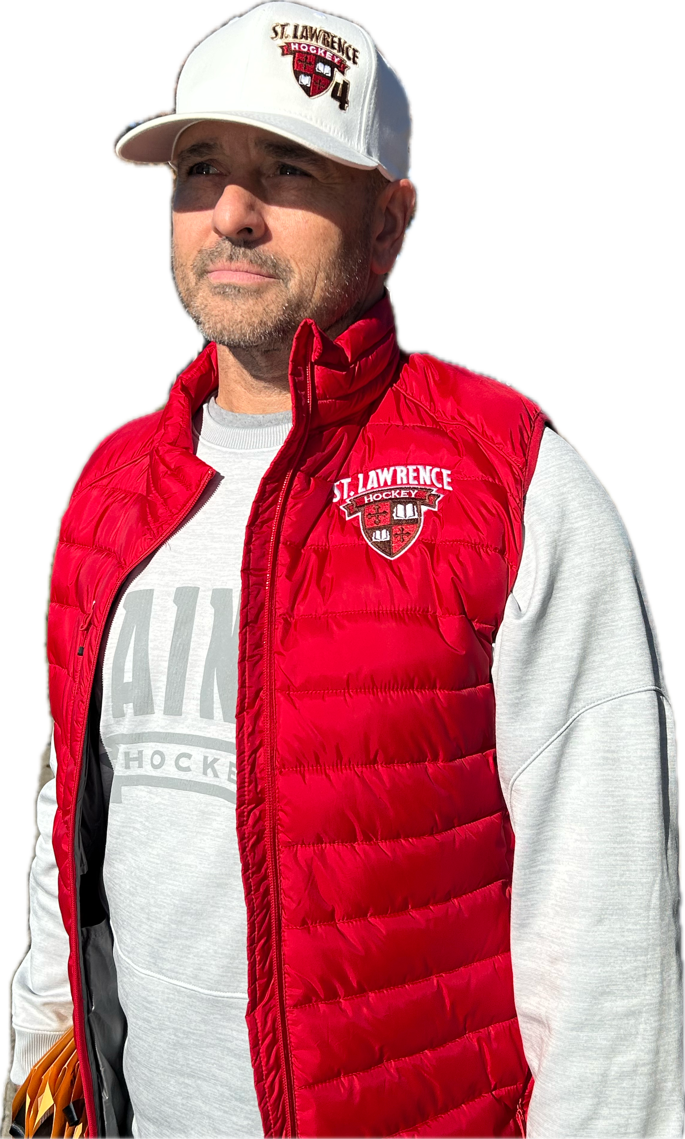 A man wearing a white baseball cap with 'St. Lawrence Hockey' logo and a red puffer vest with the same logo, over a light gray hoodie that reads 'AIK'.