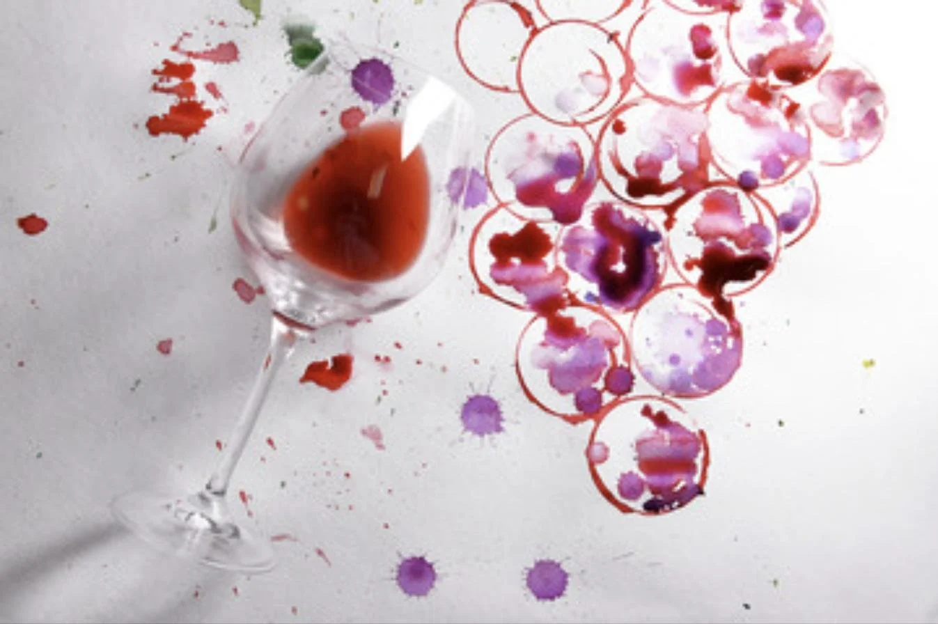 Wine glass with artistic wine stains, representing wine and art coming together