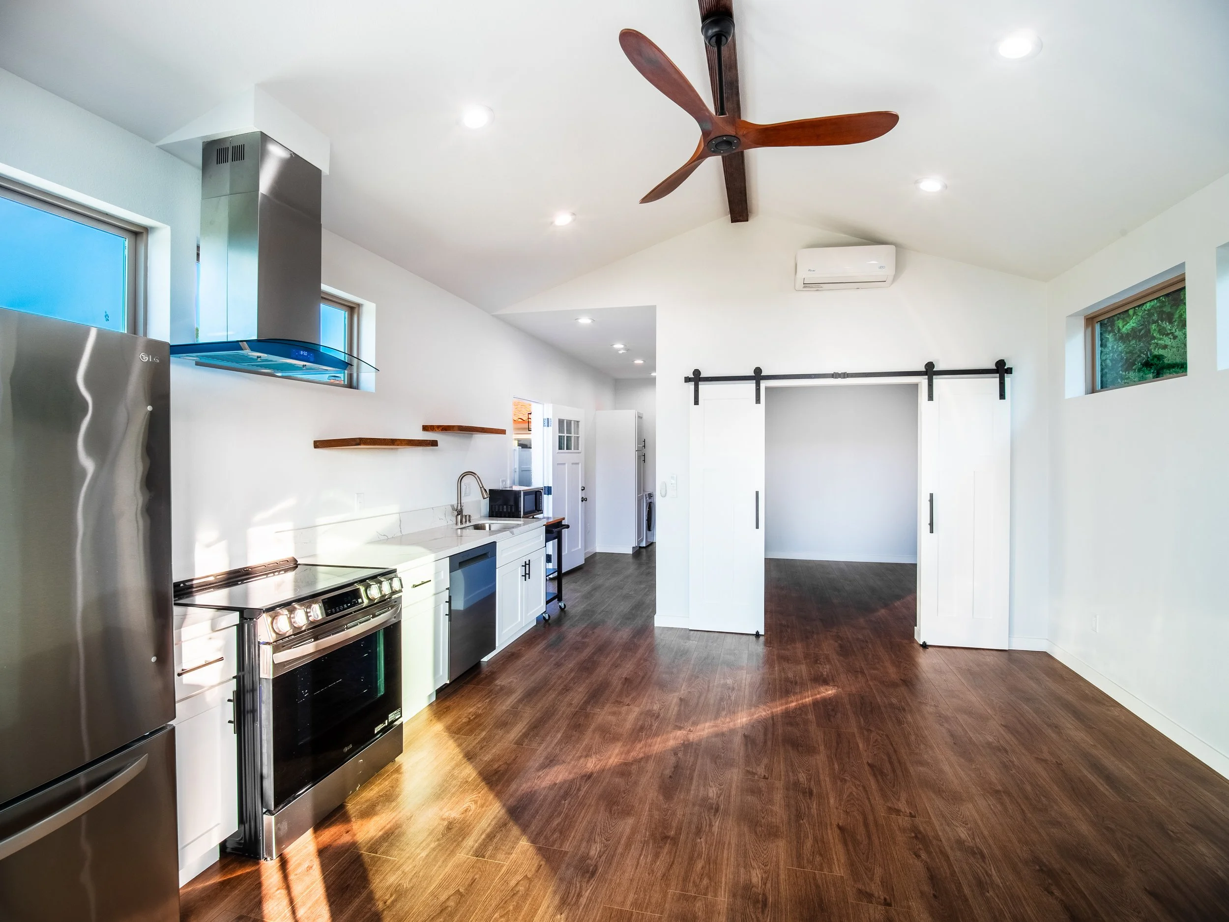 open floor plan with a bedroom (or office) space with beautiful, farm doors