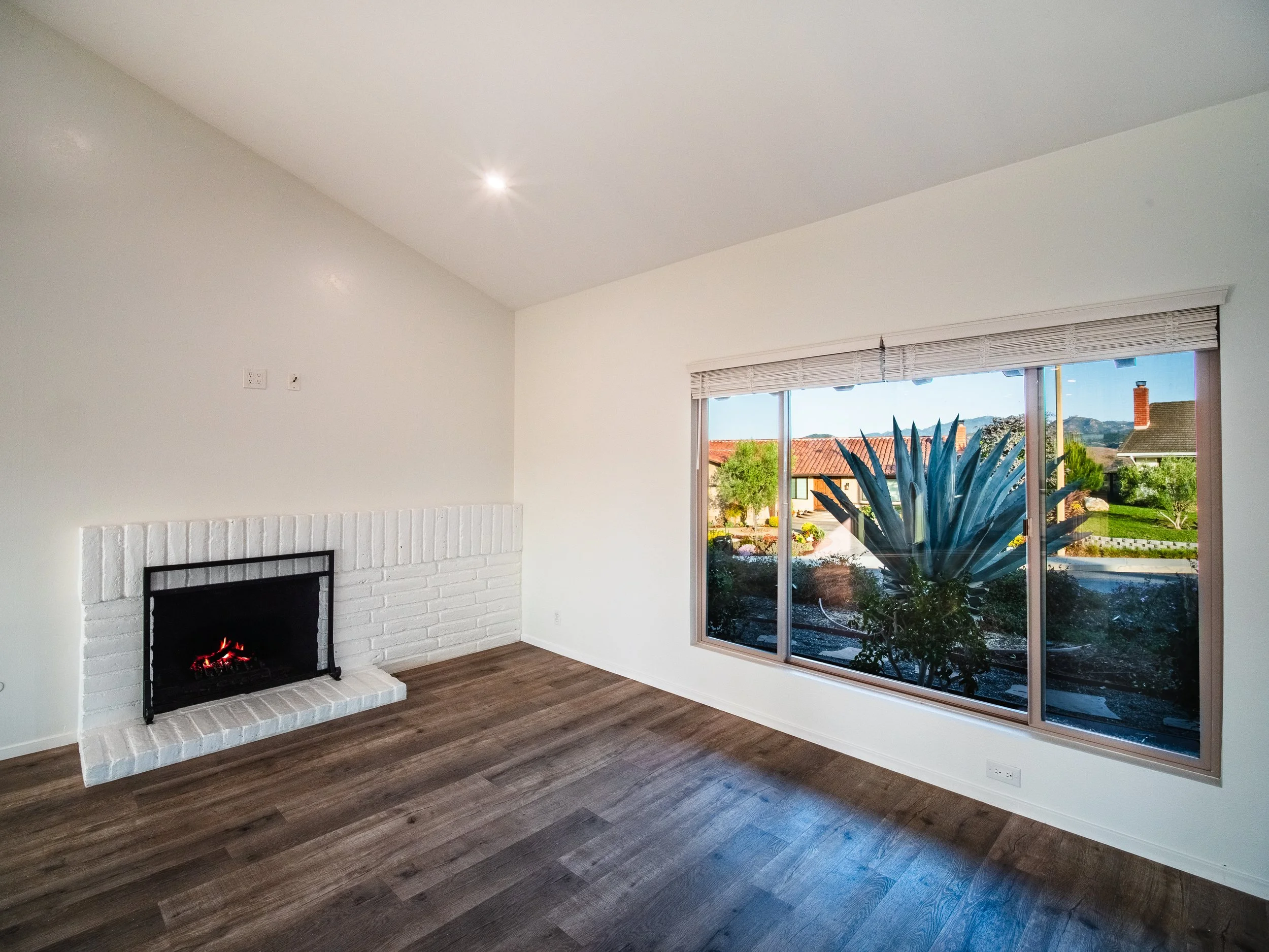 a cozy fireplace to accompany an additional living/entertainment space within the open floor plan