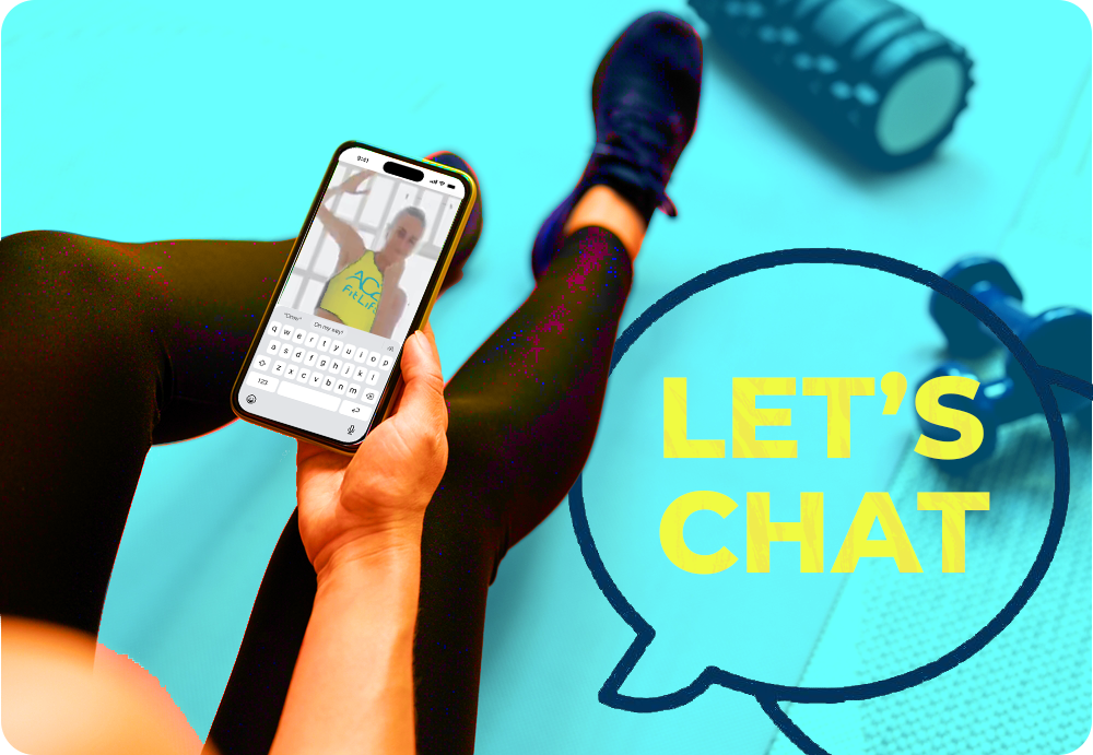 A person in workout clothes sitting on the floor, holding a smartphone and taking a selfie. There are workout equipment pieces nearby, and a speech bubble with the text "LET'S CHAT" overlays the image.