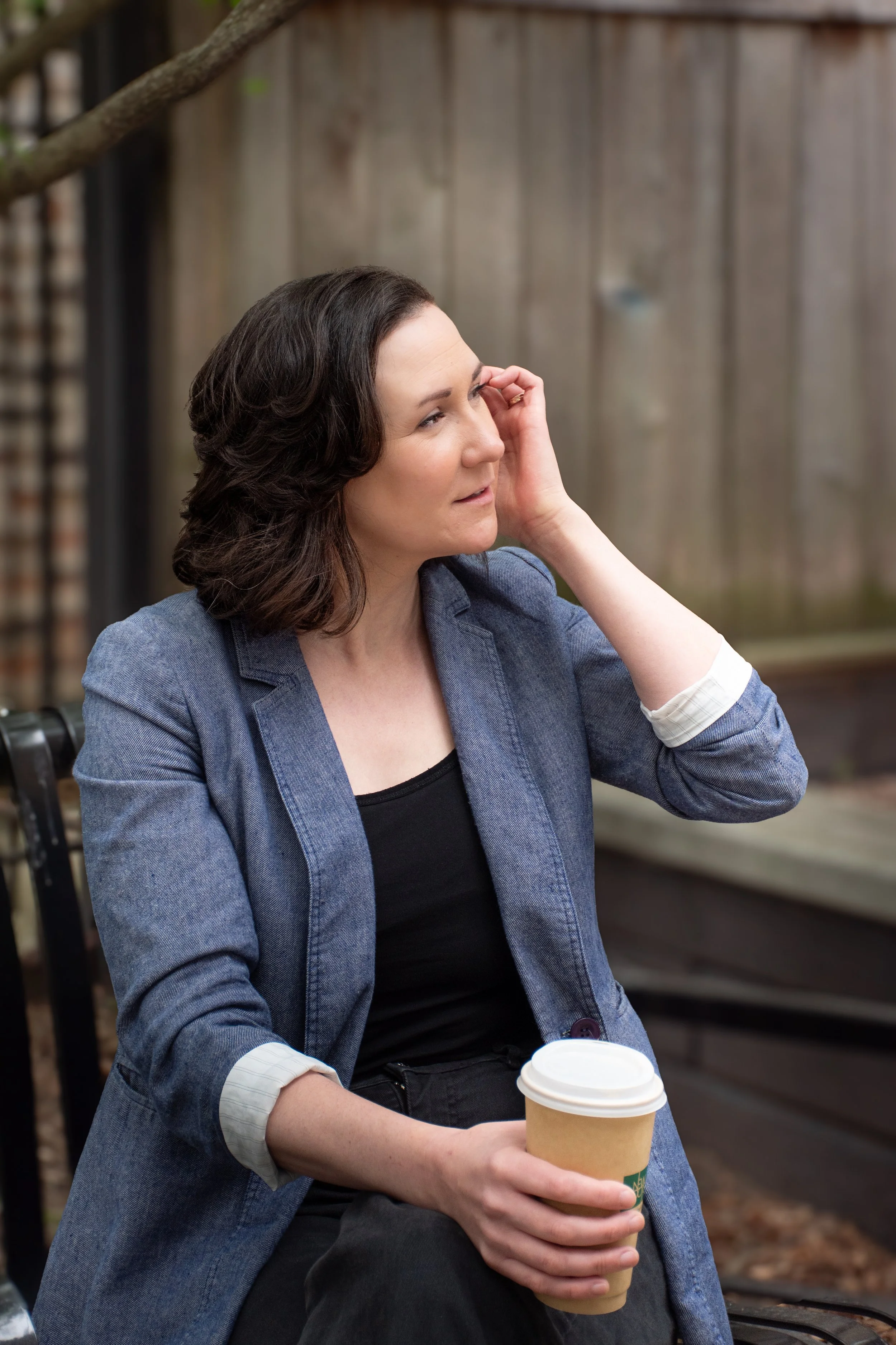 Female career coach in blue blazer listens intently. Promotional image for Make a Plan an Execute career coaching services. Photo taken in Edgewater neighborhood of Chicago.