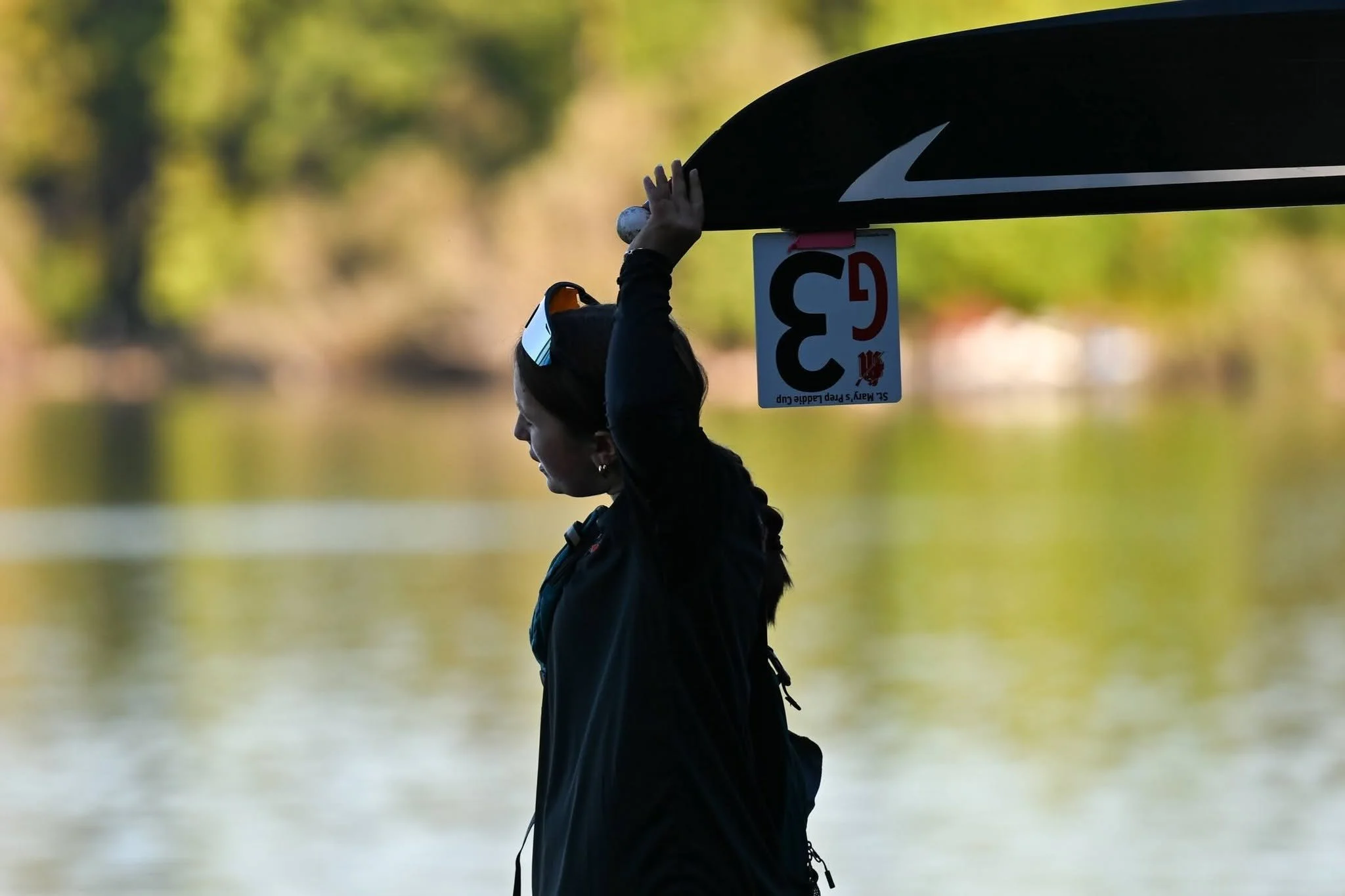 A female coxswain leads her high school rowing crew to a regatta at Orchard Lake St. Mary's in Michigan.