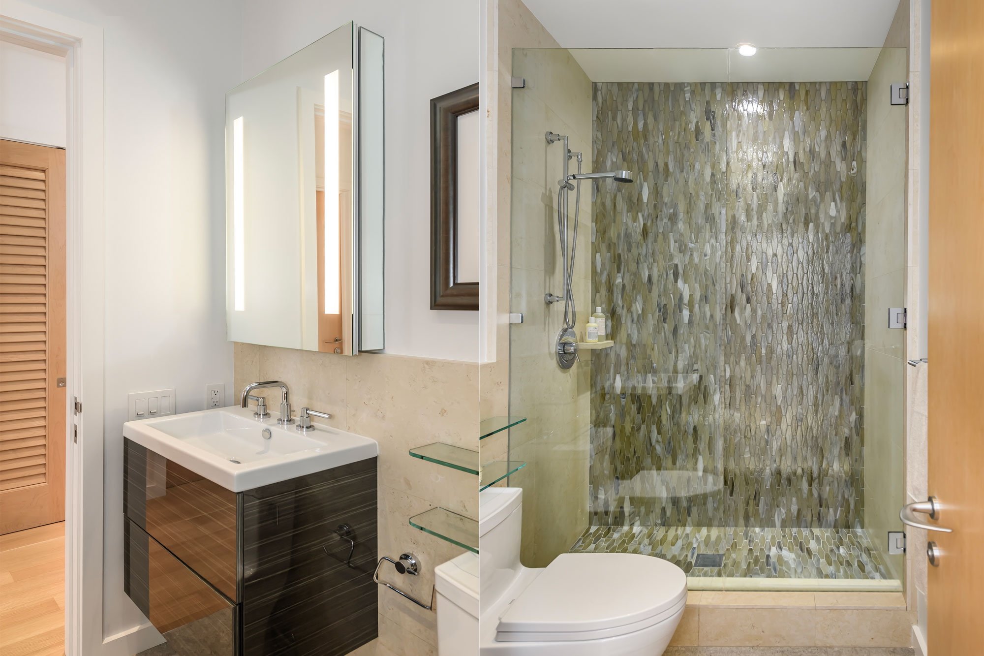 A bathroom featuring a sink with a cabinet, a mirror, a shower area with a glass wall, a rainfall showerhead, and a wall with decorative hexagonal tiles.