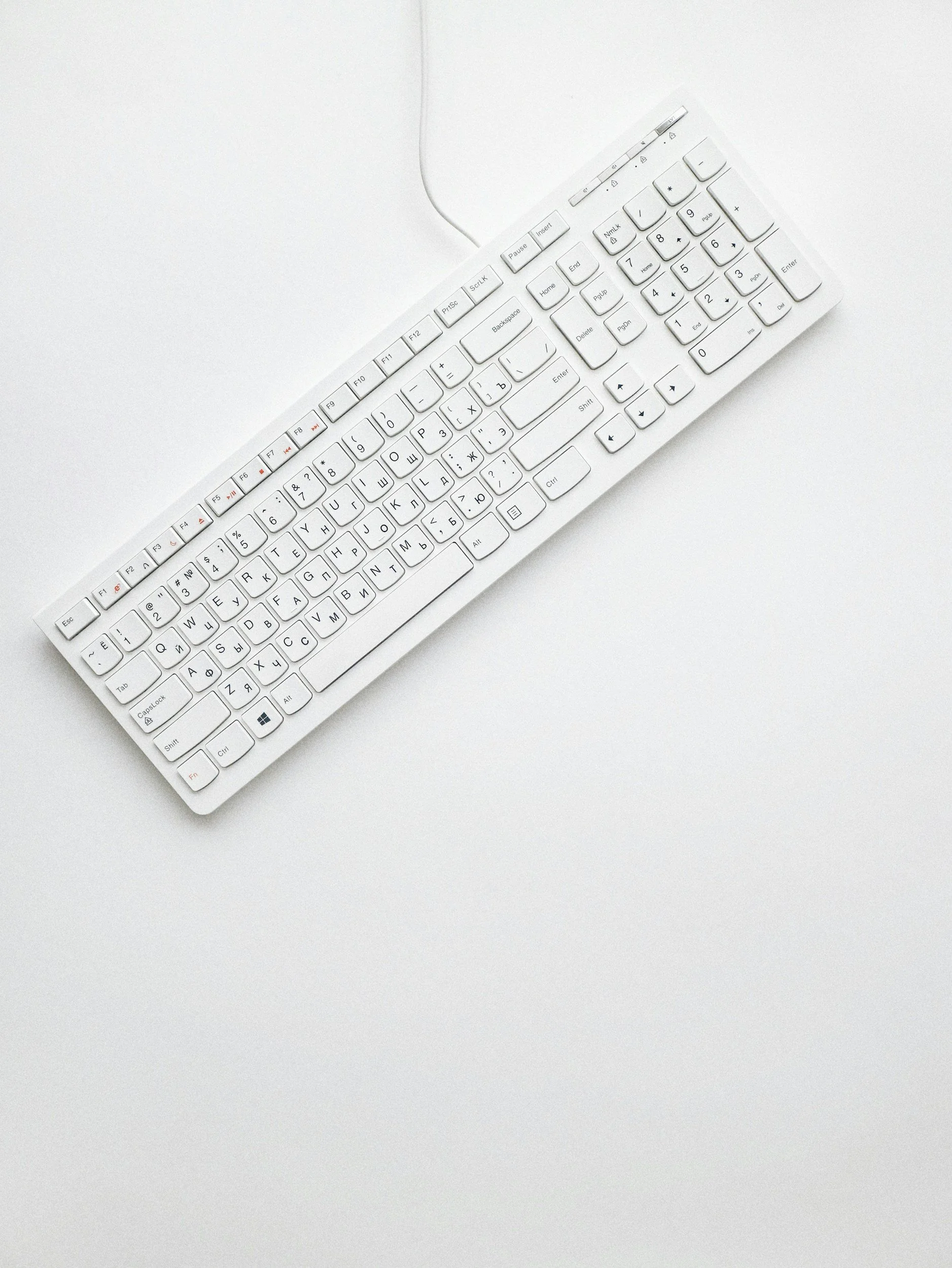 White computer keyboard on a white surface.