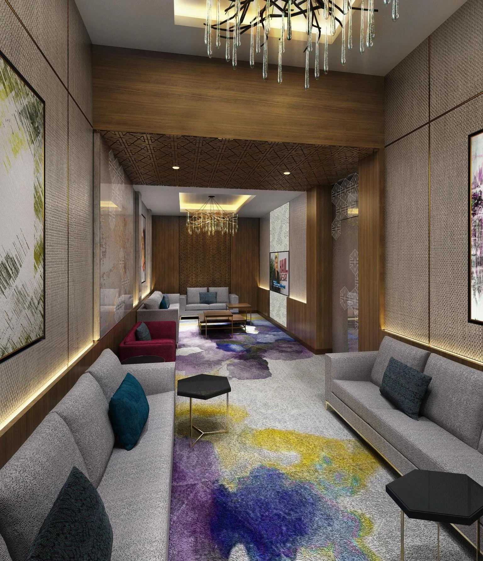 A modern hotel lobby area with multiple sofas, colorful pillows, abstract patterned carpet, framed artwork on the walls, wooden wall panels, and a decorative ceiling with pendant lighting.