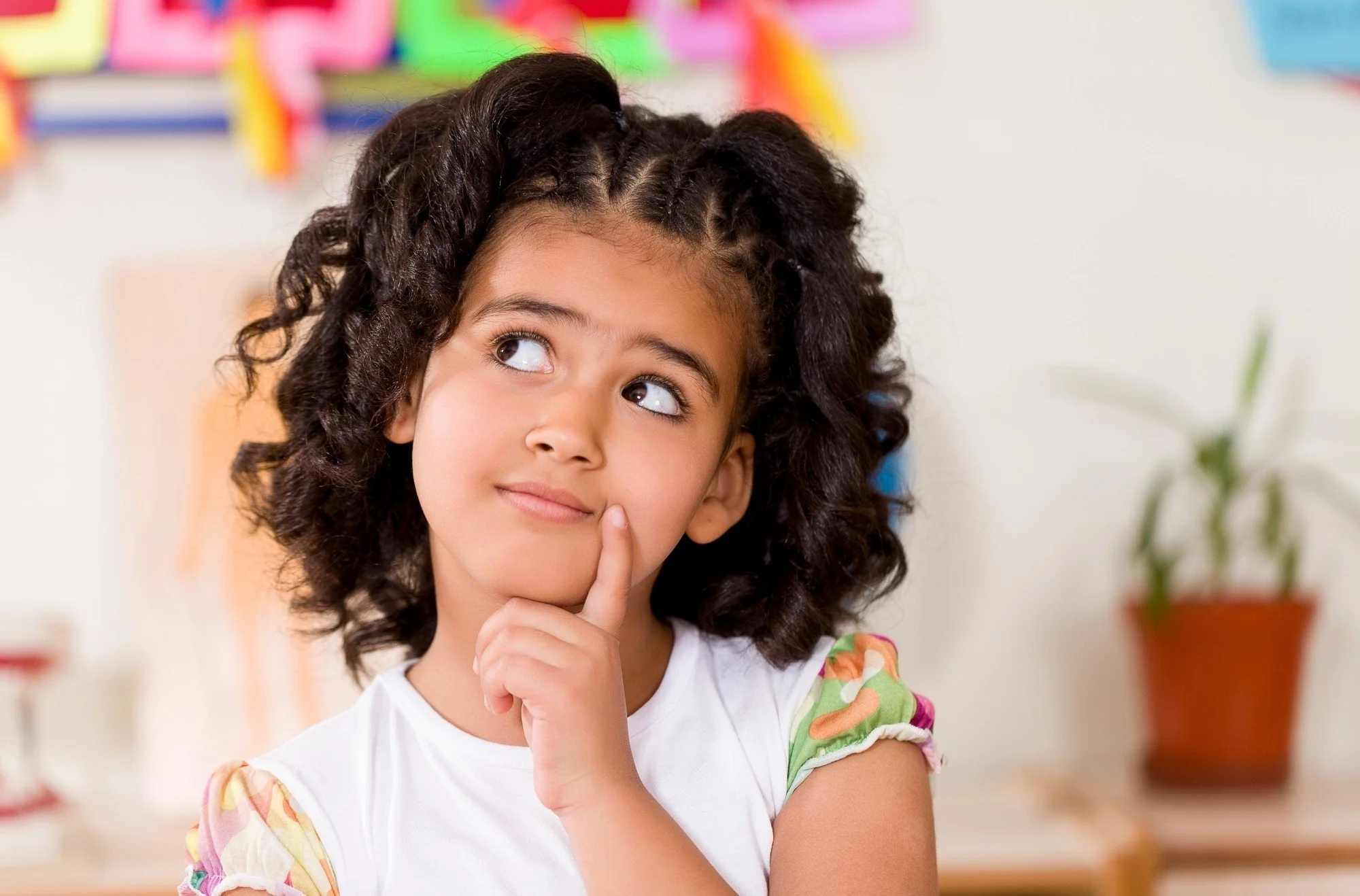 A young girl looking up thoughtfully next to the frequently asked questions about ABA therapy and autism services in Thomasville, Davidson County, and Forsyth County, NC.