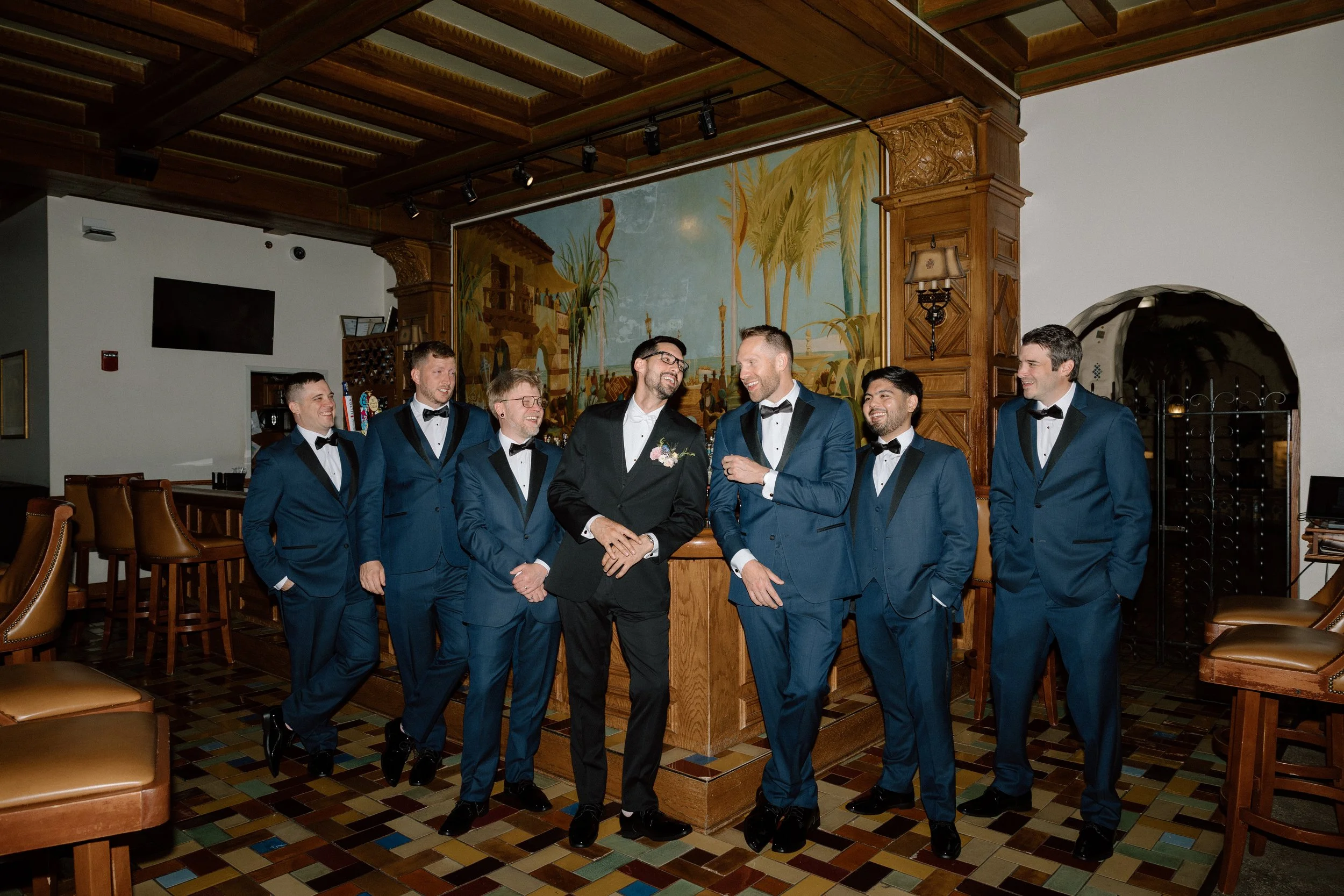 Groom and groomsmen standing casually