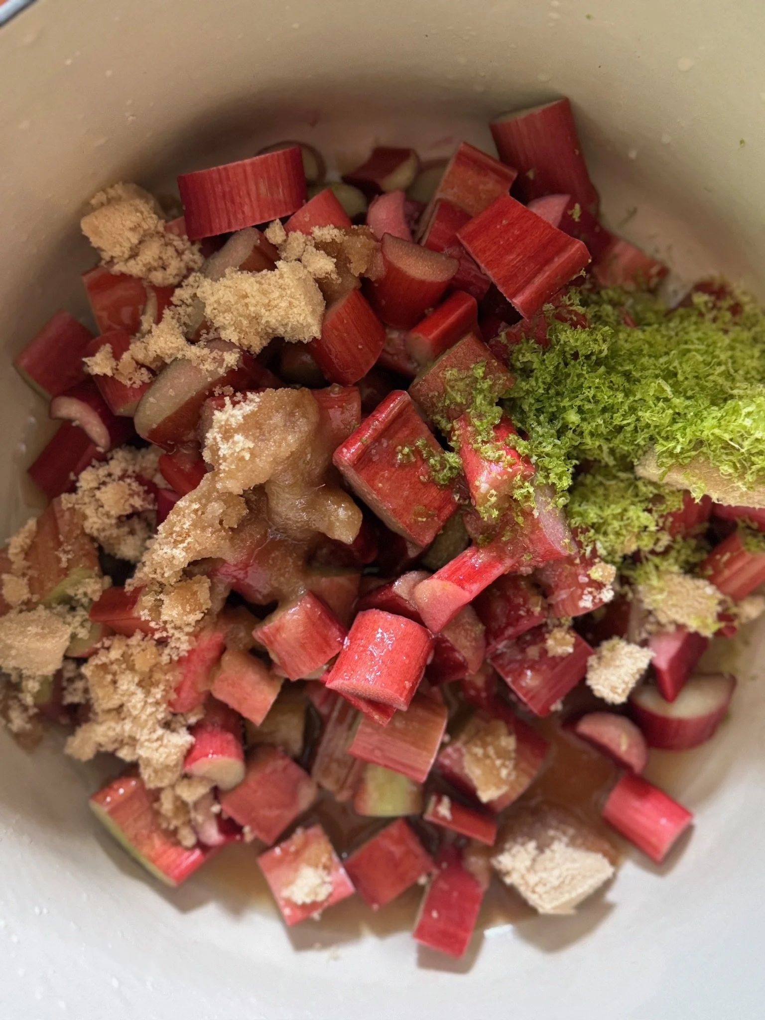 Chopped rhubarb with sugar in a cooking pot.
