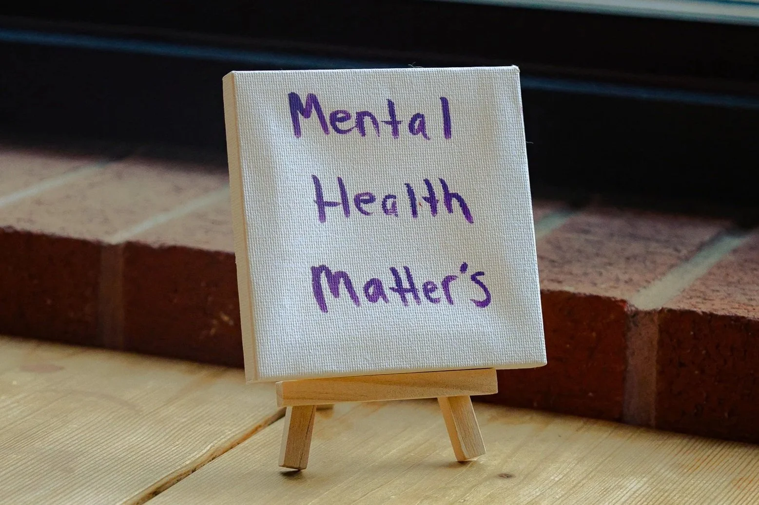 Small canvas on mini easel with handwritten purple text saying 'Mental Health Matters'