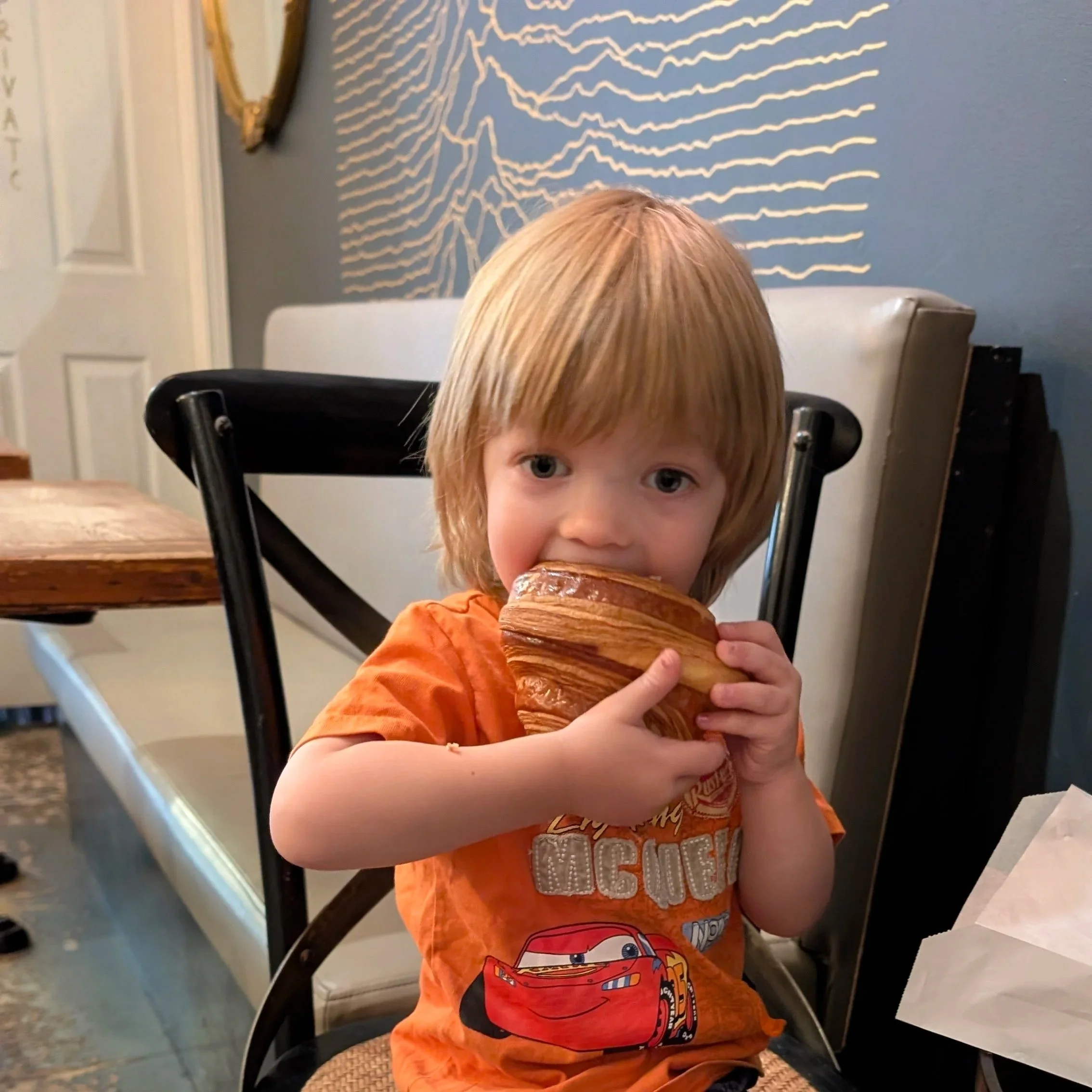William with a croissant in Cafe 23