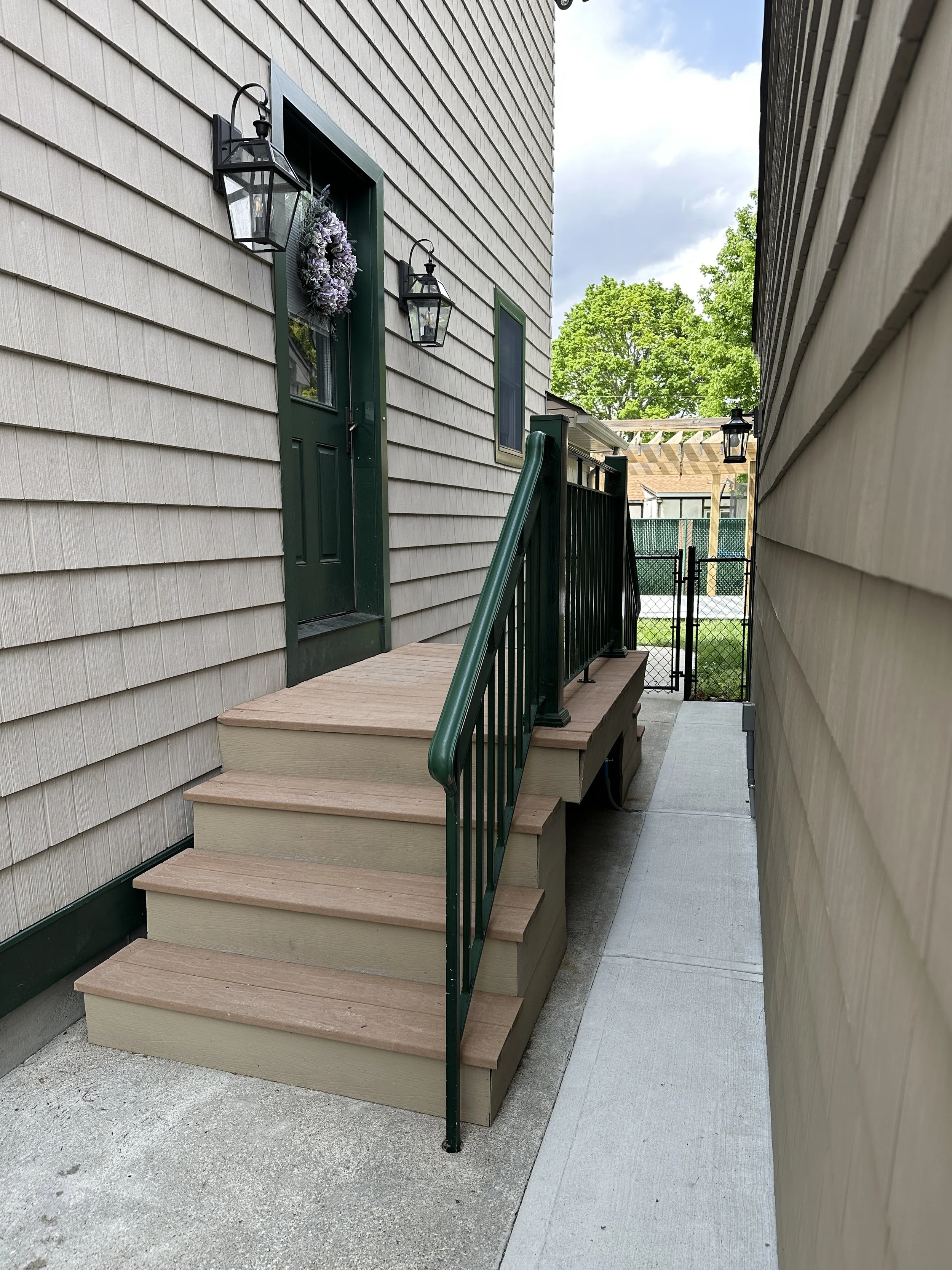 AFTER - Wow is this even the same house? It is! Concrete cleaned and sealed! Staircase + Railings cleaned too!