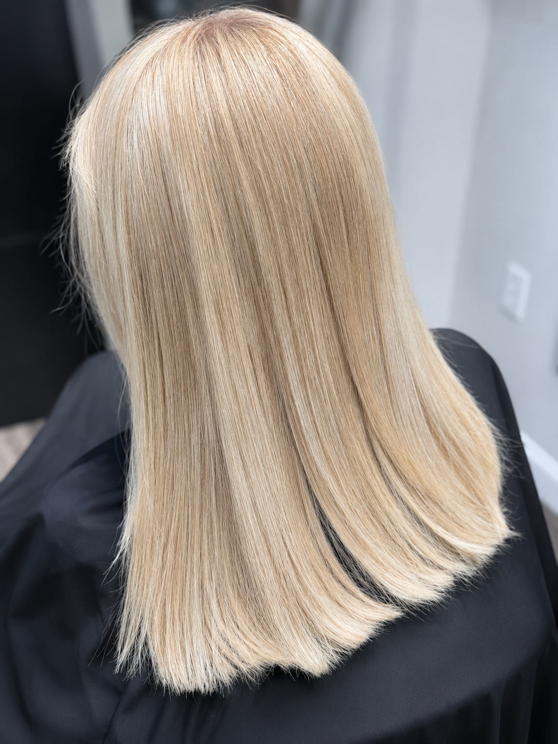 Smooth blonde hair after a professional smoothing treatment at Bare Roots Hair Studio in Aberdeen, NC.