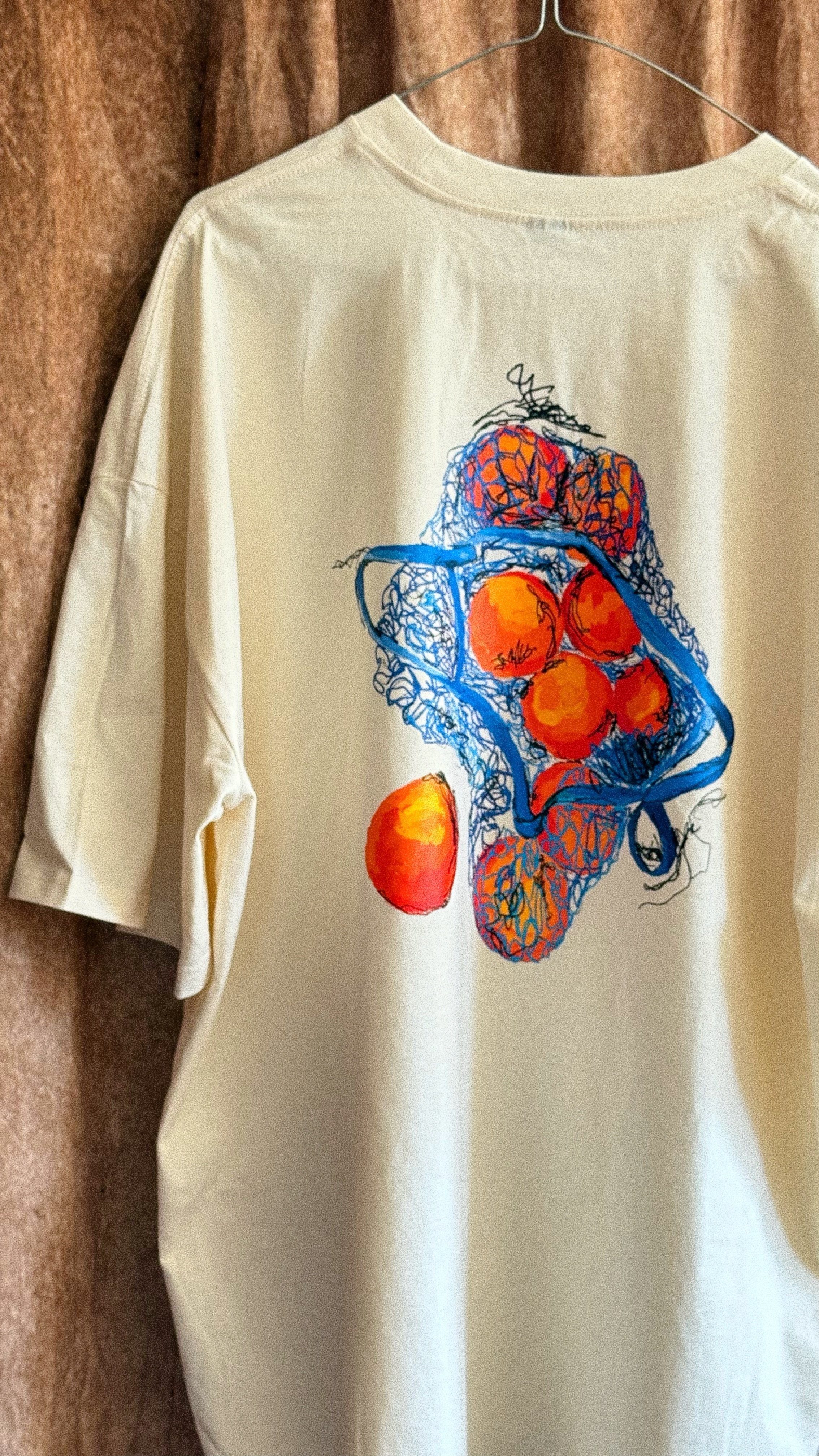 oranges in blue tee