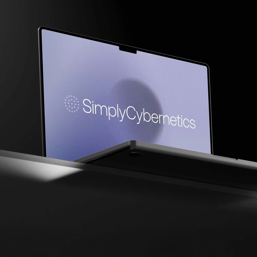 A computer monitor displaying the SimplyCybernetics logo on a blue background.