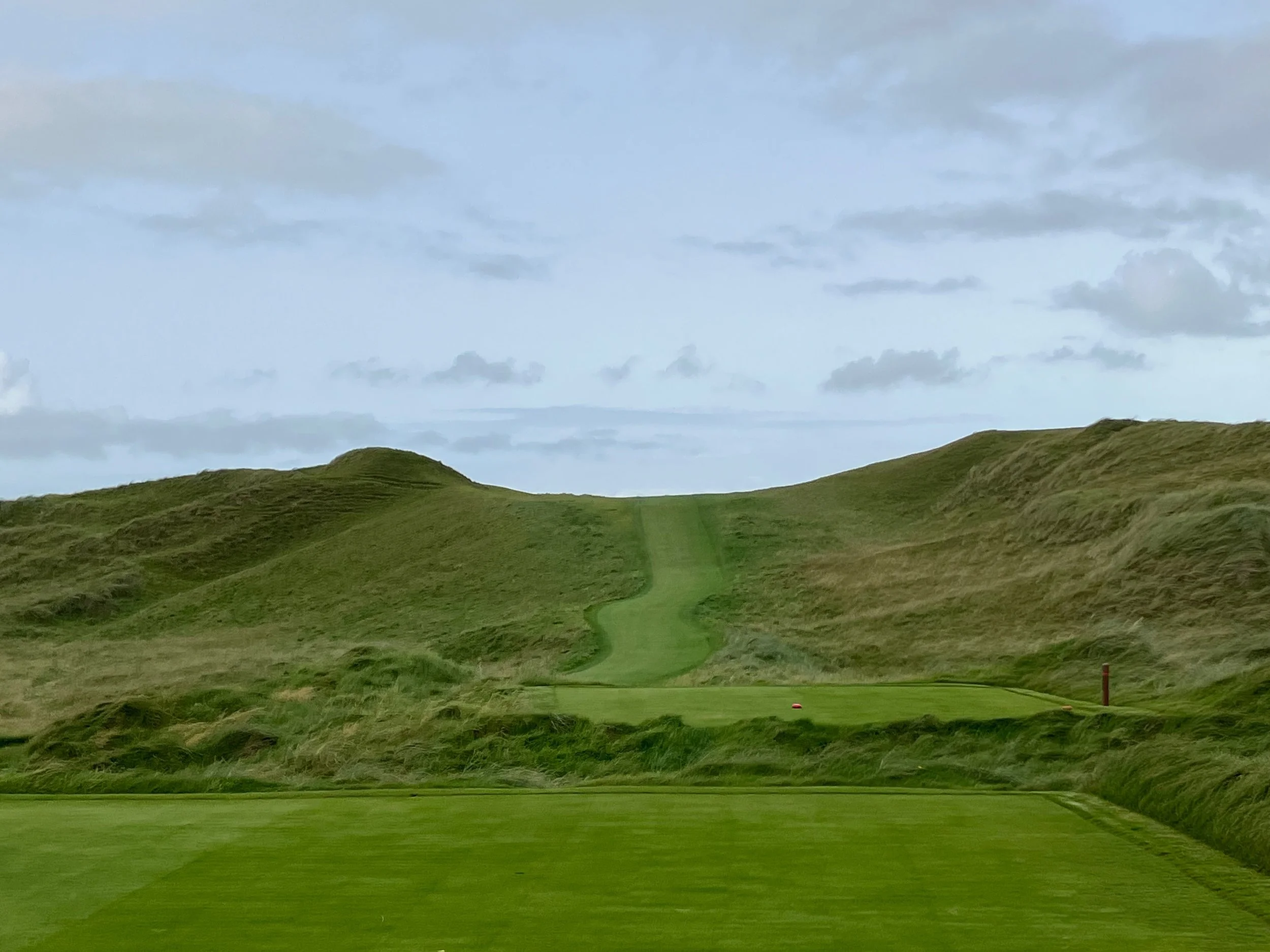 A "blind tee shot" at Lahinch Golf Club in Ireland. You cannot see where your ball will land, and a caddie can help you here.