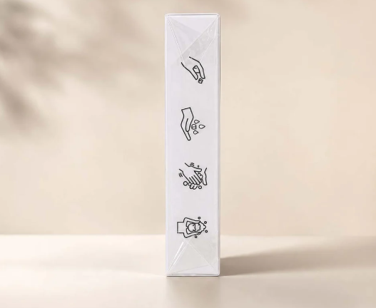 Close-up of a white boxed item with black line illustrations showing hand hygiene steps.