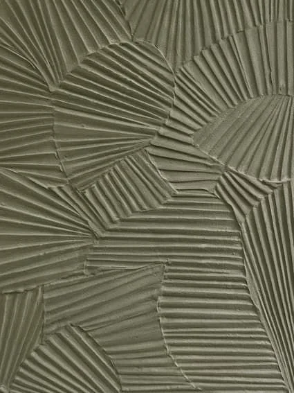 Close-up of textured, overlapping, fan-like patterns made from a light-colored, ridged material, resembling a decorative wall or artistic surface.