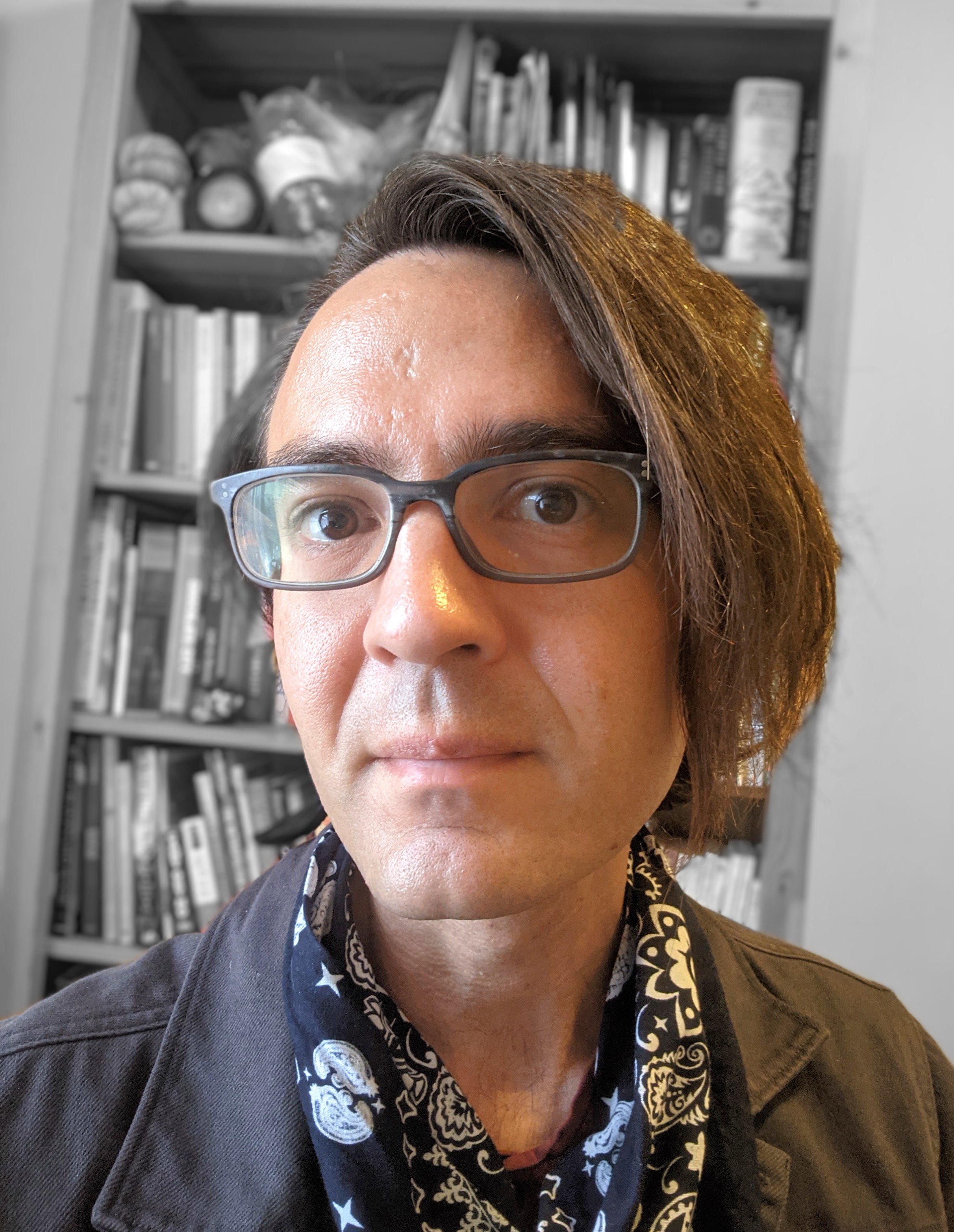Headshot of daniele ginsberg, a middle-aged white person with glasses and asymmetric hair