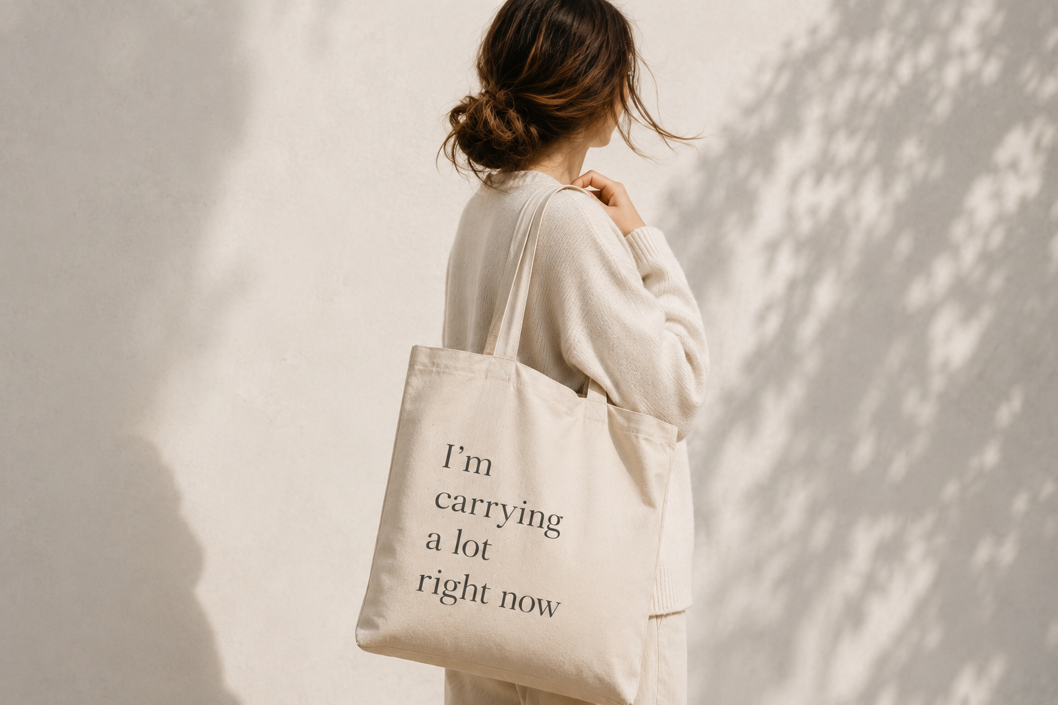 A woman with bag saying "i'm carrying a lot right now" suggesting burnout, overwhelm, anxiety, stress, family issues