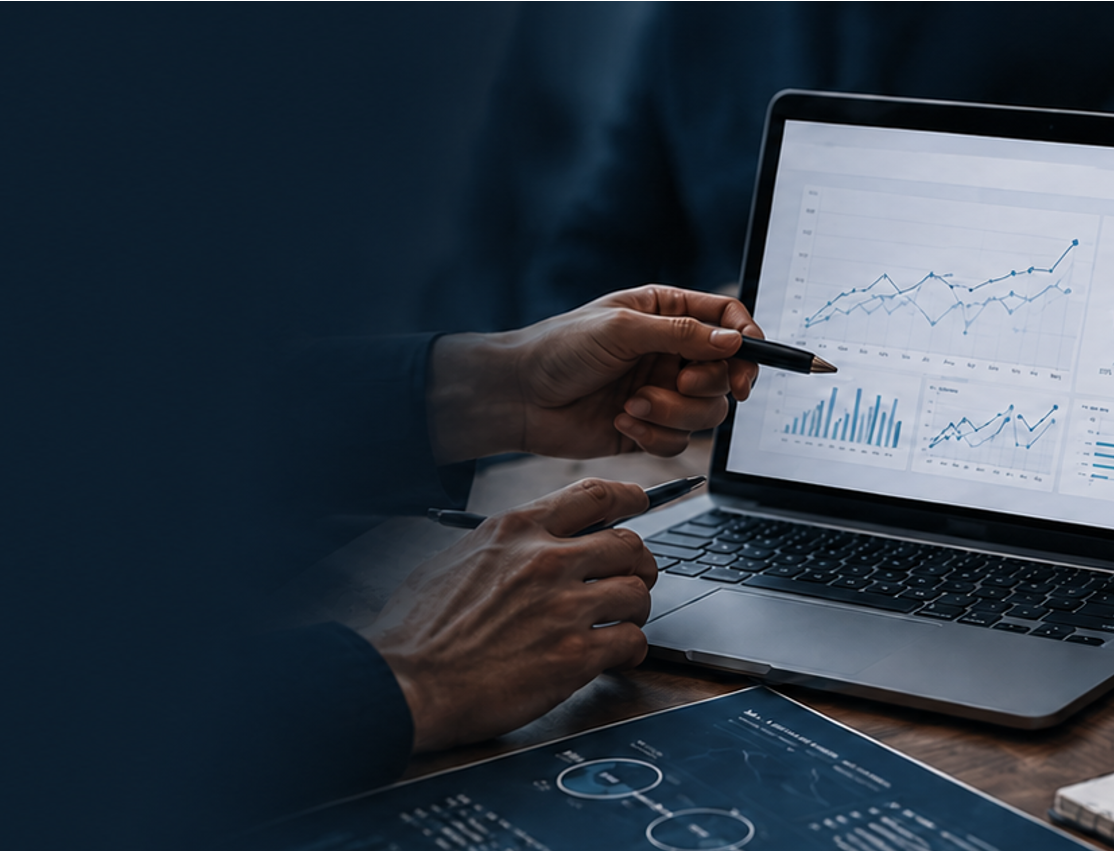 Person analyzing financial graphs on a laptop and paper charts.