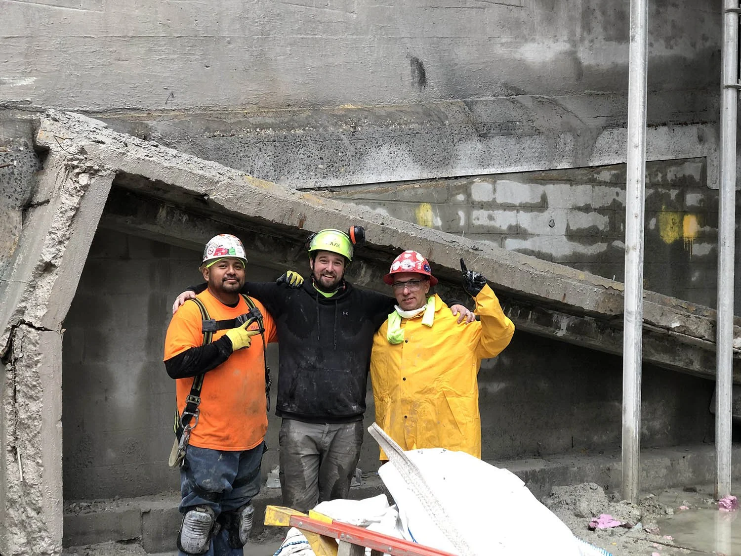 A group of three happy hand sawing contractors