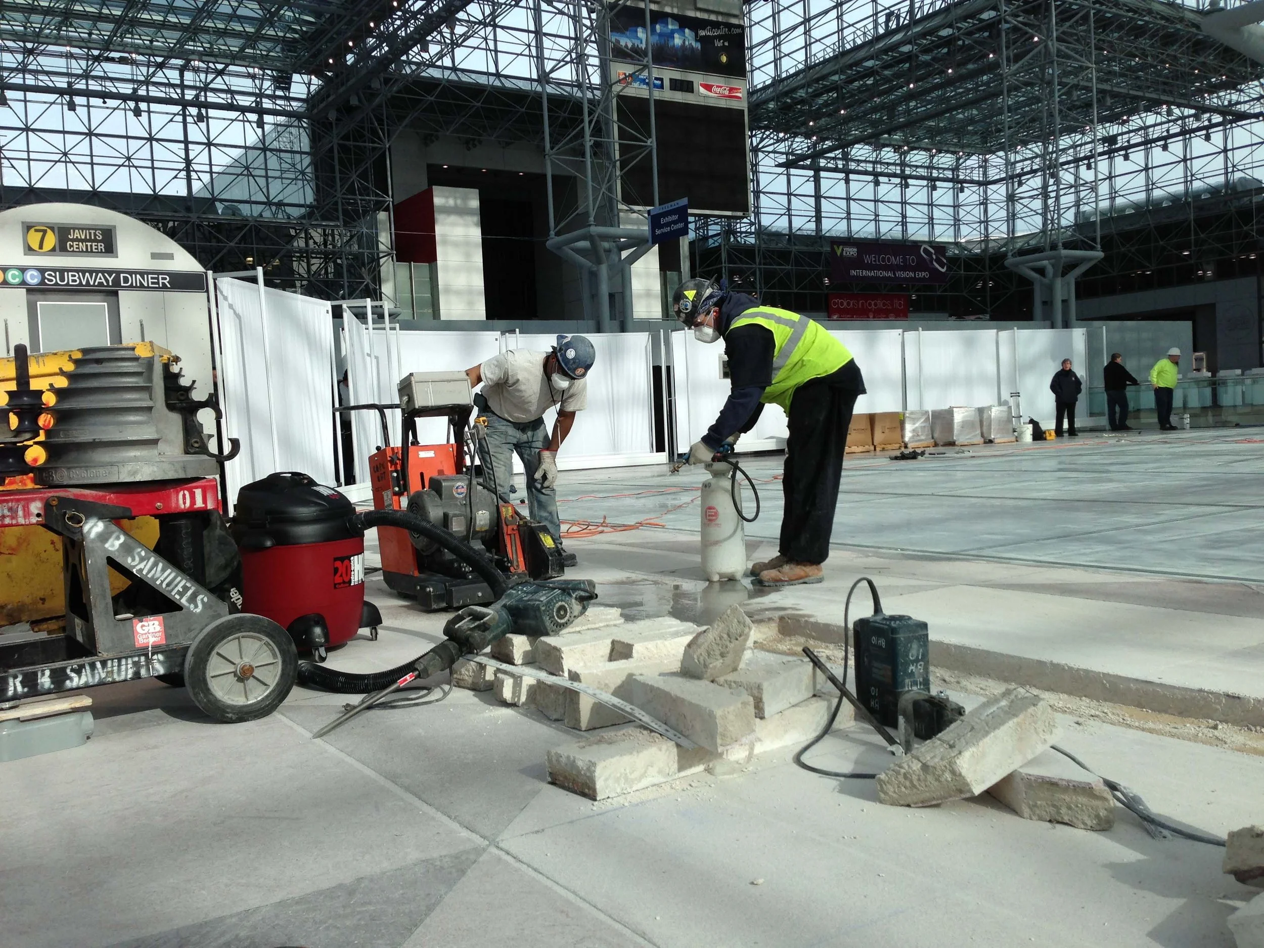 Contractors cutting trench with a slab saw
