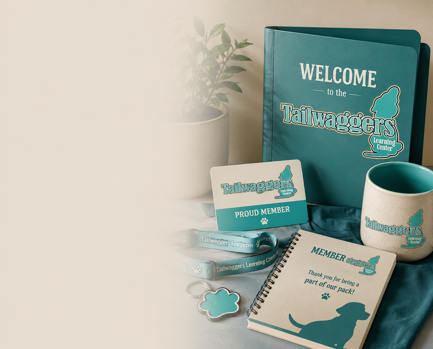 Tailwaggers Learning Center member welcome kit featuring a welcome binder, membership card, notebook, mug, lanyard, and branded merchandise for dog training club members in Florida.