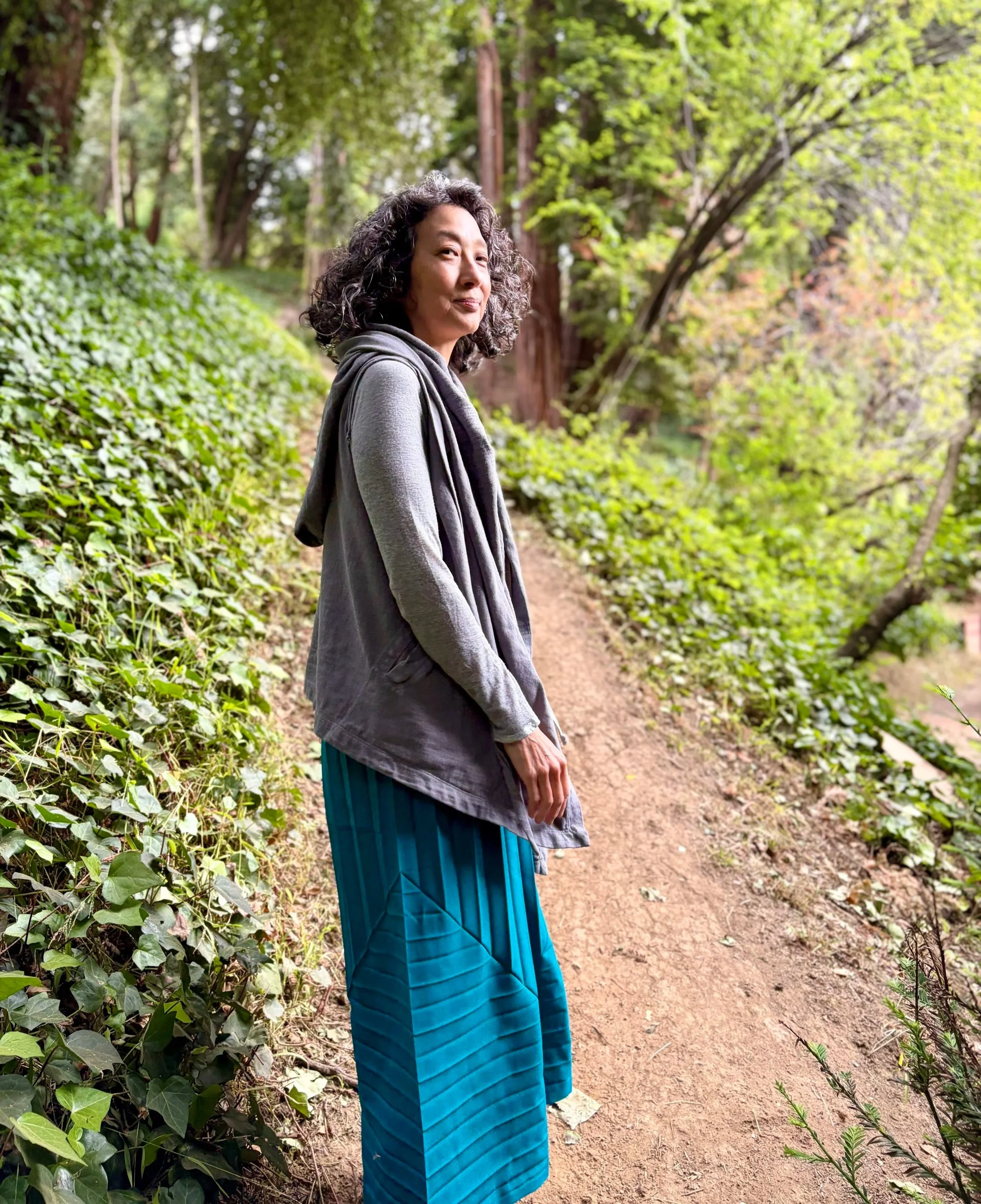 Portrait of coach and writer Erica Ando outdoors.