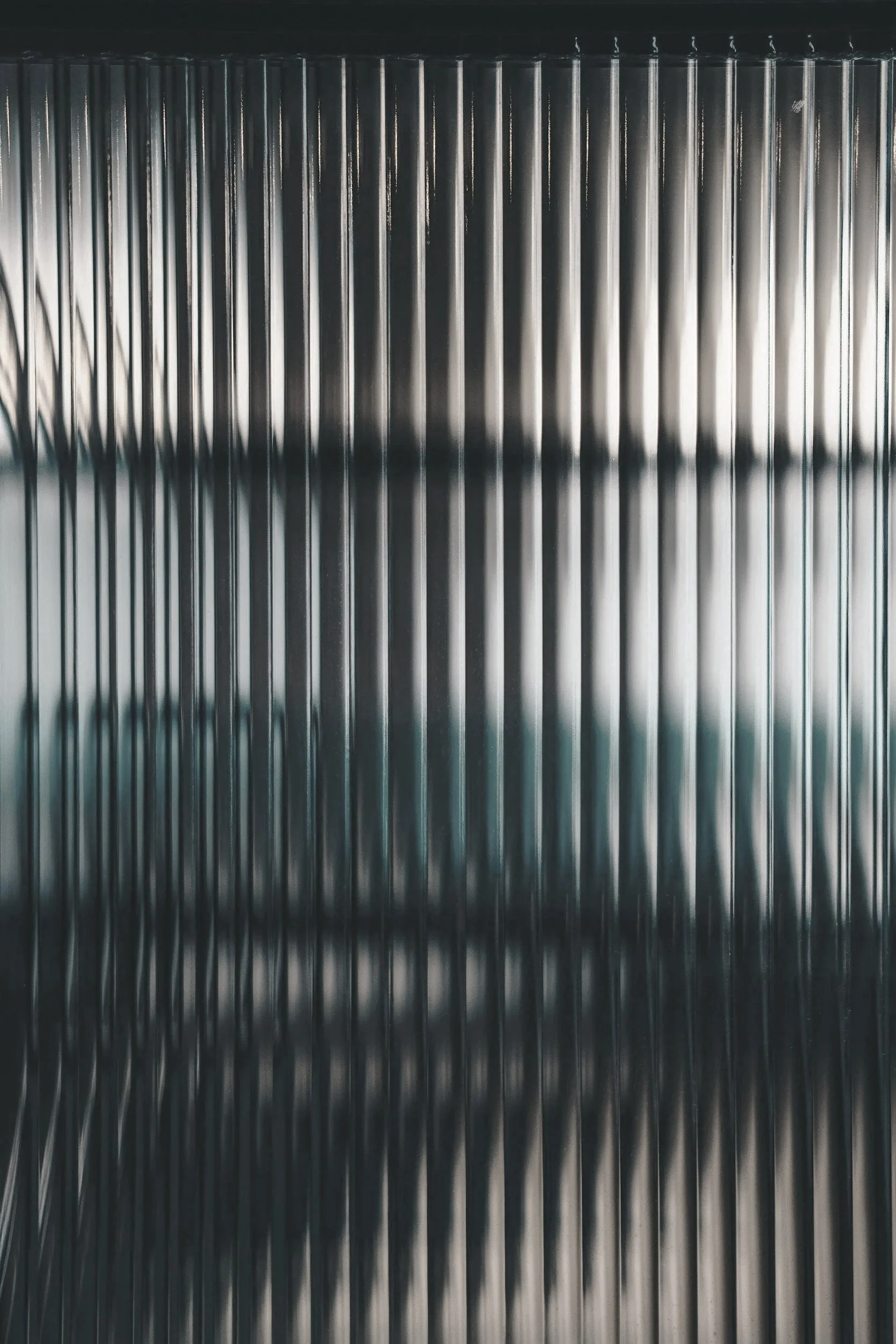 Close-up of a metallic surface with vertical ridges.