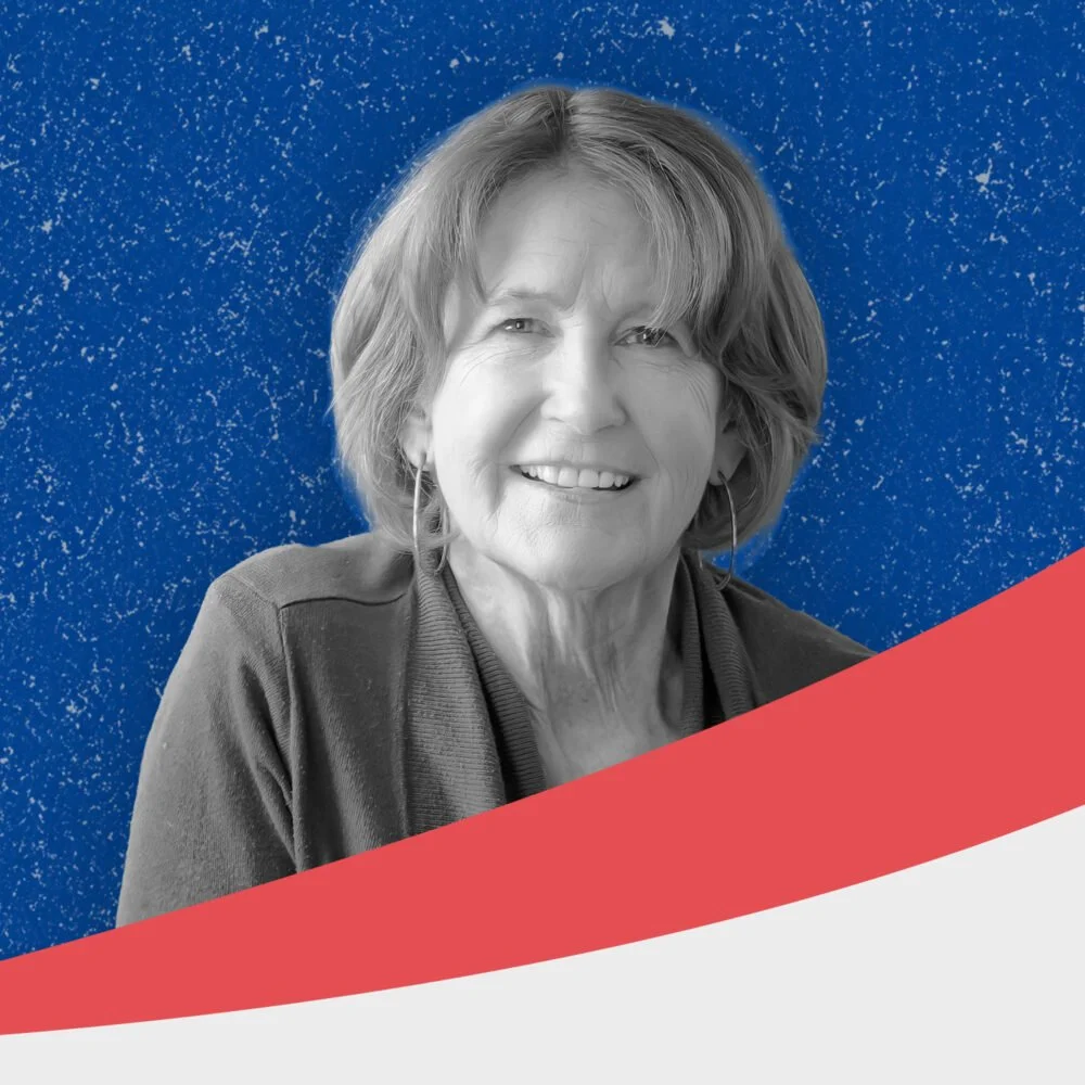A black and white portrait of a smiling older woman with shoulder-length hair, wearing earrings and a jacket, set against a decorative blue background with white speckles, and a graphic red and white curved design at the bottom.