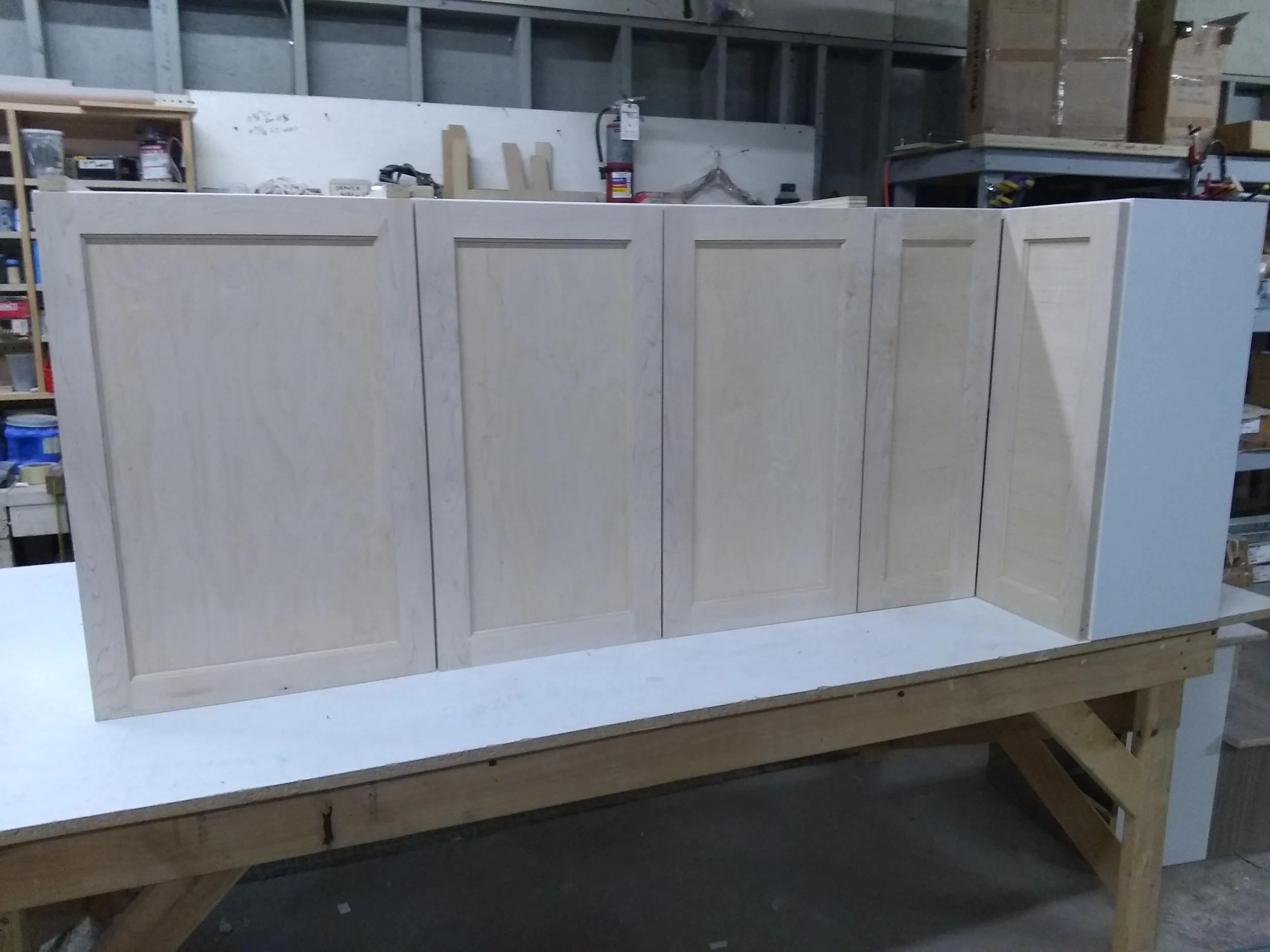 Custom made kitchen cabinet in construction, positioned on a workbench in a workshop, with tools and materials visible in the background.
Custom cabinetry. Kitchen cabinets made of solid  wood .
#bigjohnsco #CustomFurniture #MadeFromScratch #HomeRemo