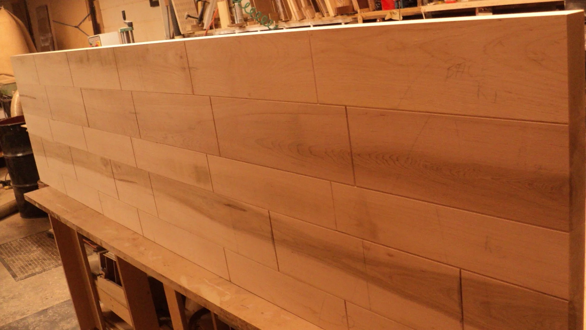 The material is glued, but in such a way that it can be separated for transport into an NYC apartment.
