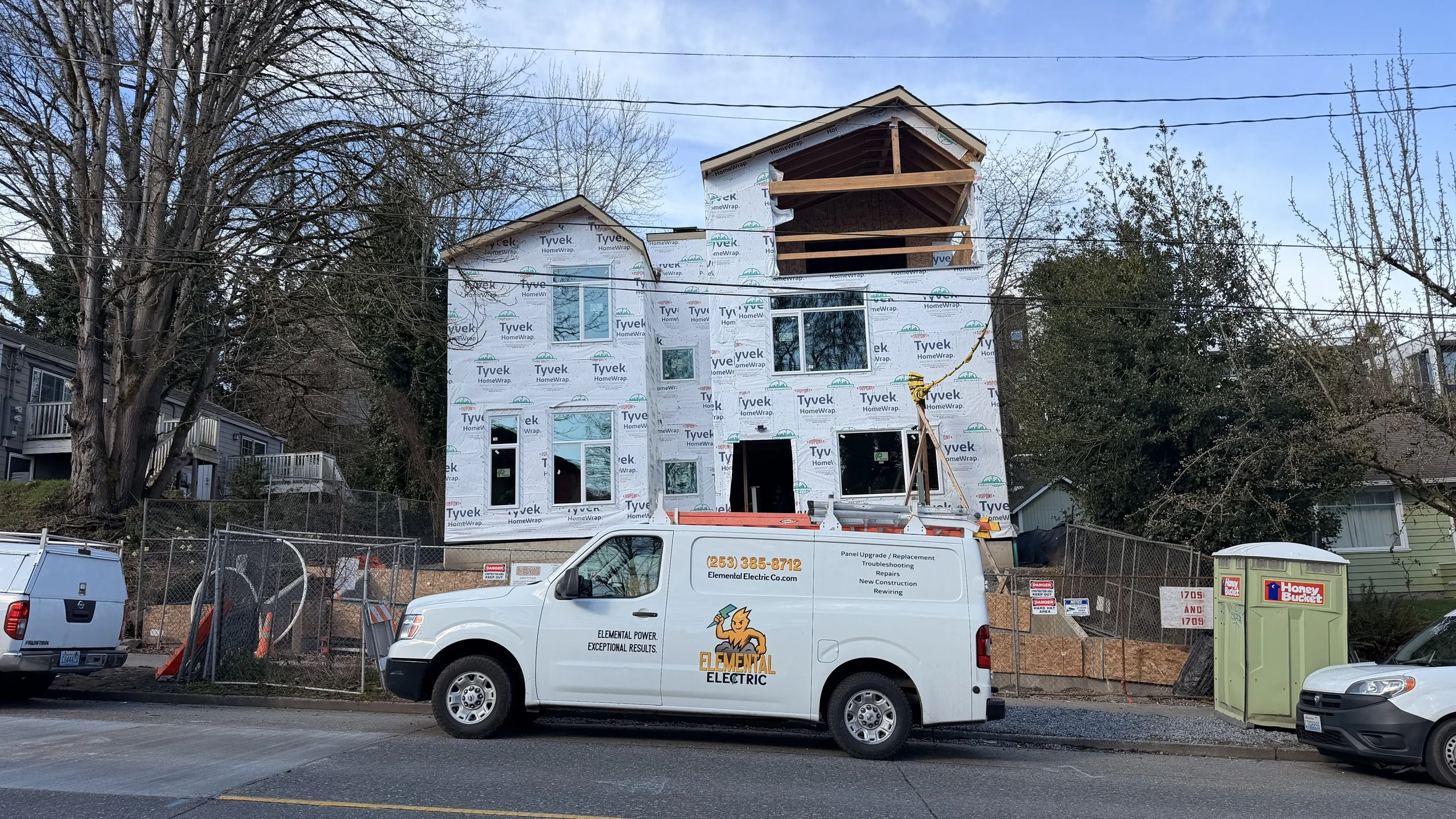 Elemental Electric electrical contractor vehicle at a residential new construction site in Seattle.