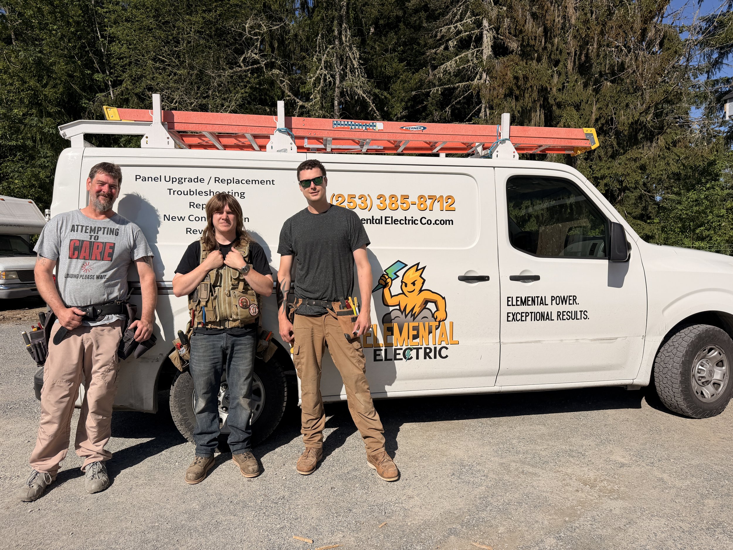 Three people standing in front of a white service van with tree-filled background. The van has signage and the employees are dressed in work gear, with tools attached to their belts.