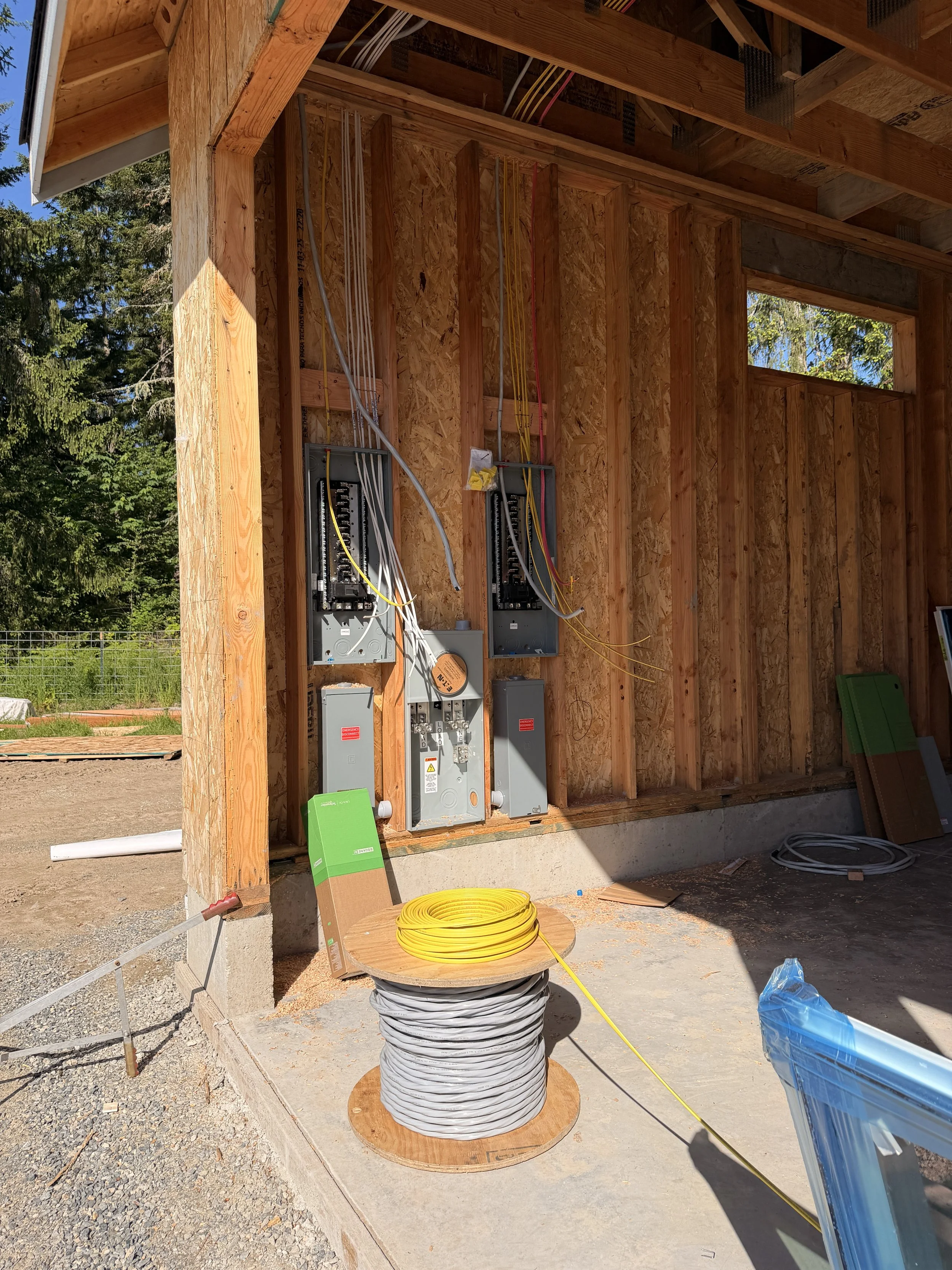 New residential electrical panel installation in garage during home construction in Graham, WA.