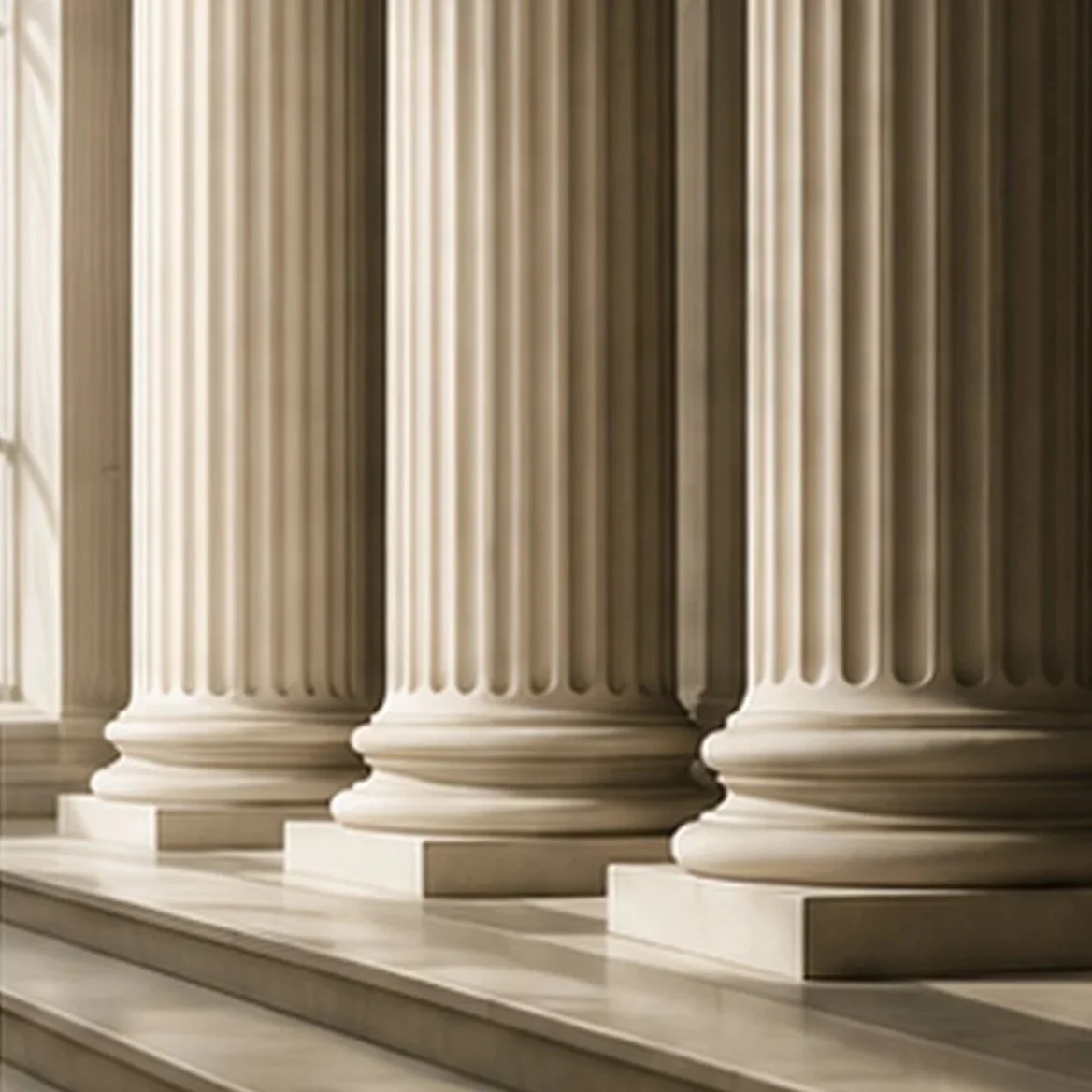 Close-up of large white classical columns with fluted design in a government or historic building