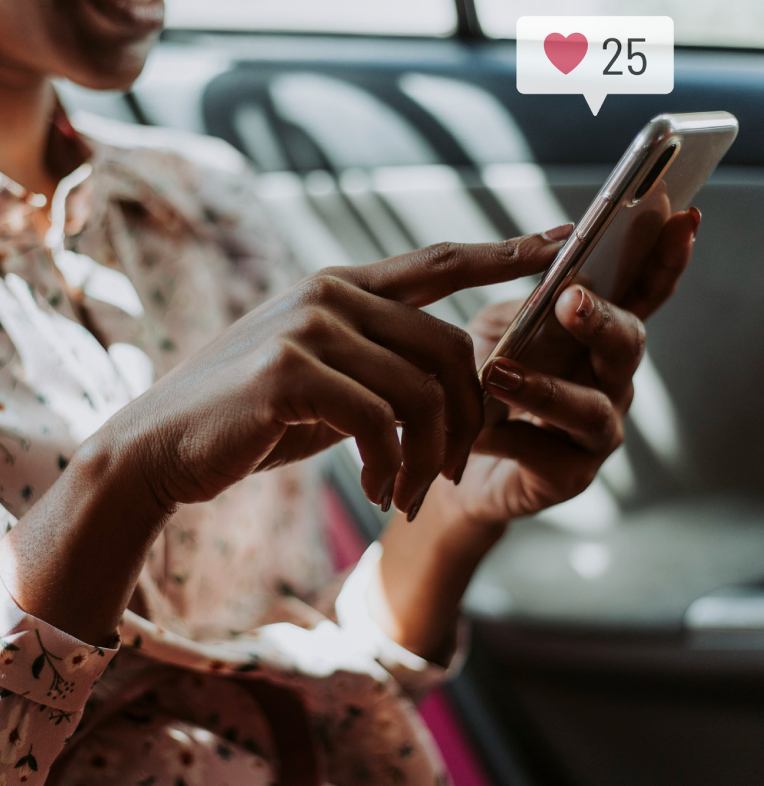 A woman is sitting on a bus or train, using her smartphone, which displays a likes notification with 25 likes. She is wearing a floral-patterned blouse.