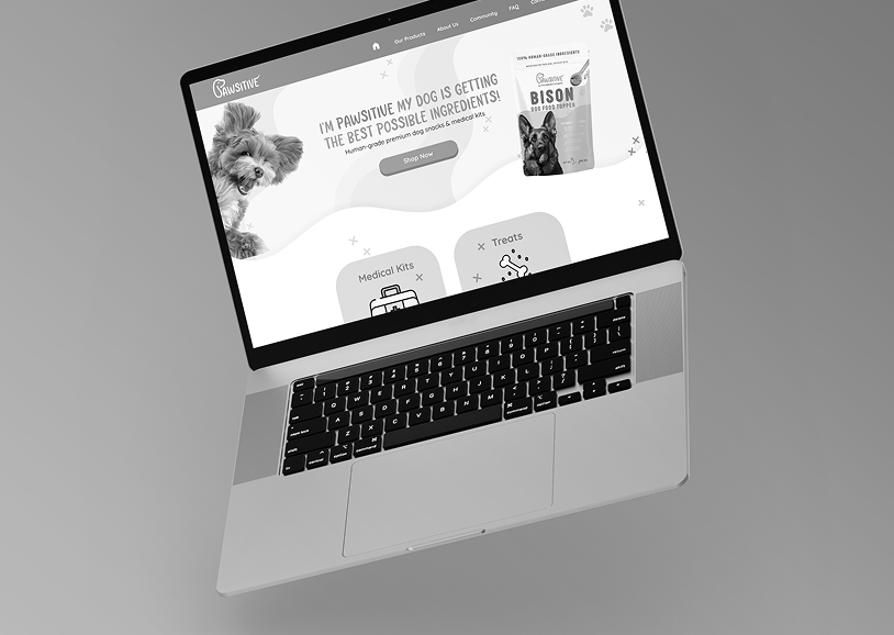 A silver laptop displaying a pet-related website with images of dogs and text promoting pet food products.