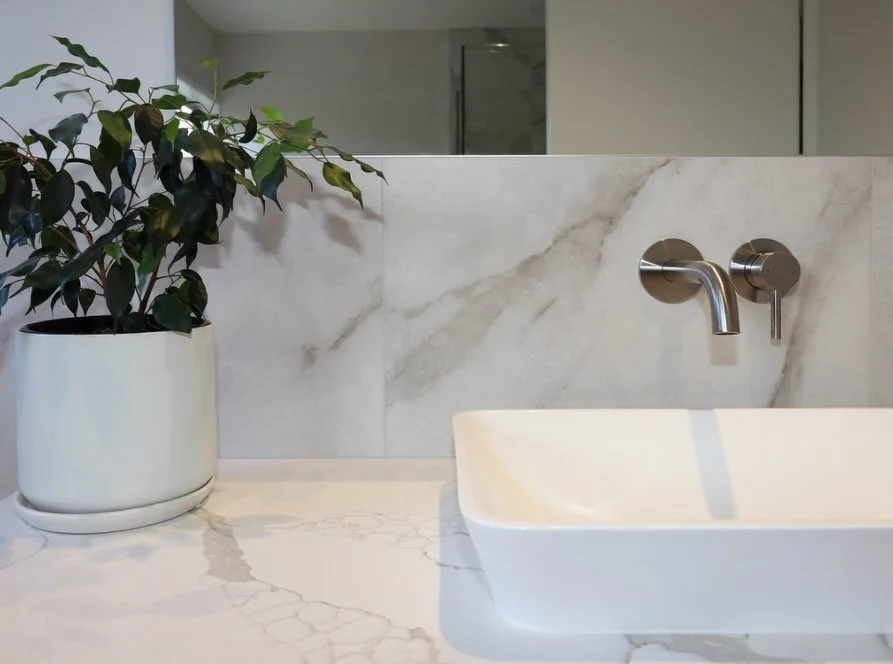 Semi-recessed basins are a lovely way to have the elegance of a standalone basin, with a practical easy-to-clean profile. We love the look of this one paired with the soft marbles and brushed nickel hardware.