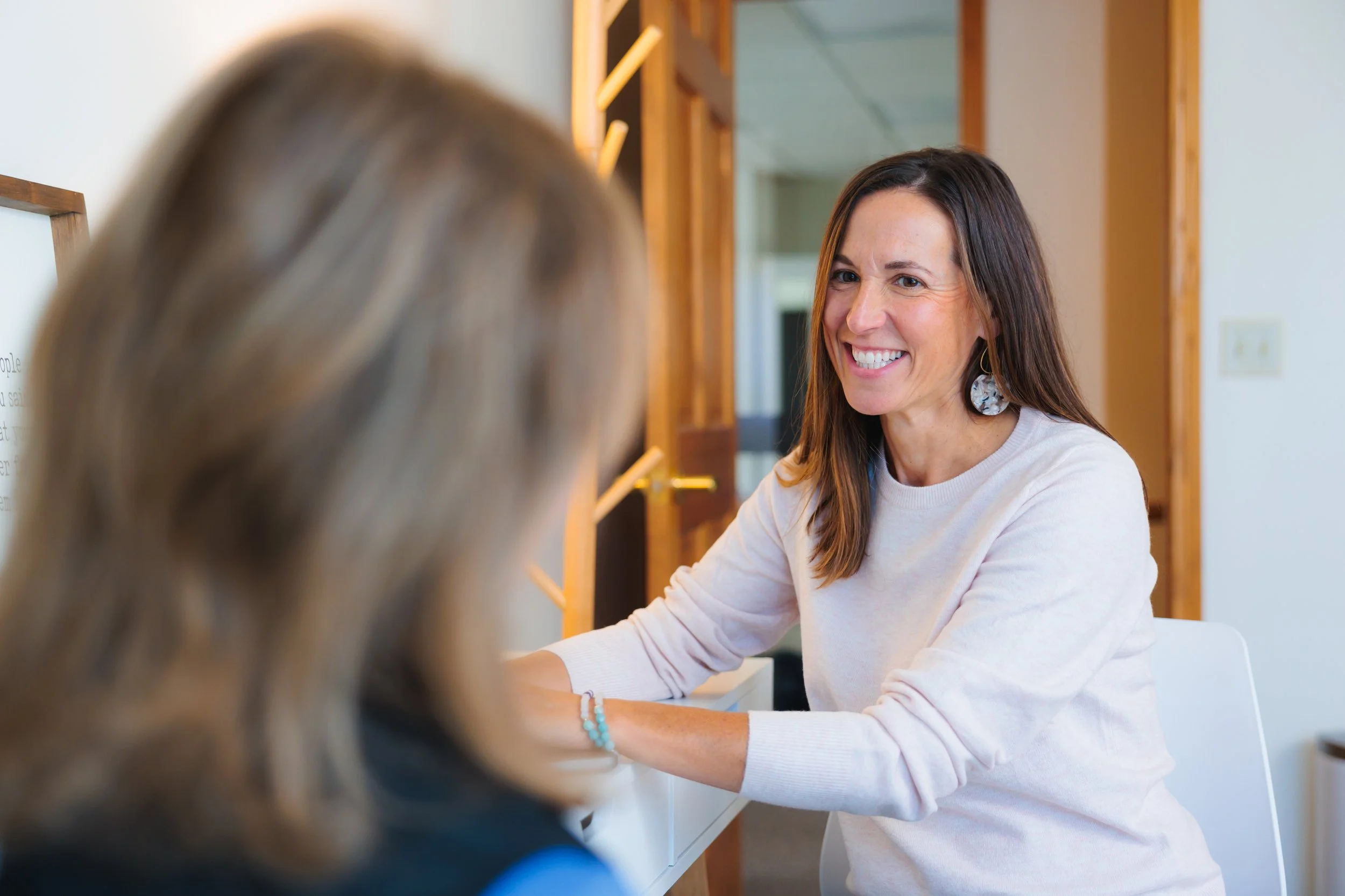 Pelvic health physical therapist meeting with a patient for bladder leakage, urgency, and frequency concerns at Cultivate Your Wellbeing, serving Mequon and Brookfield, Wisconsin.
