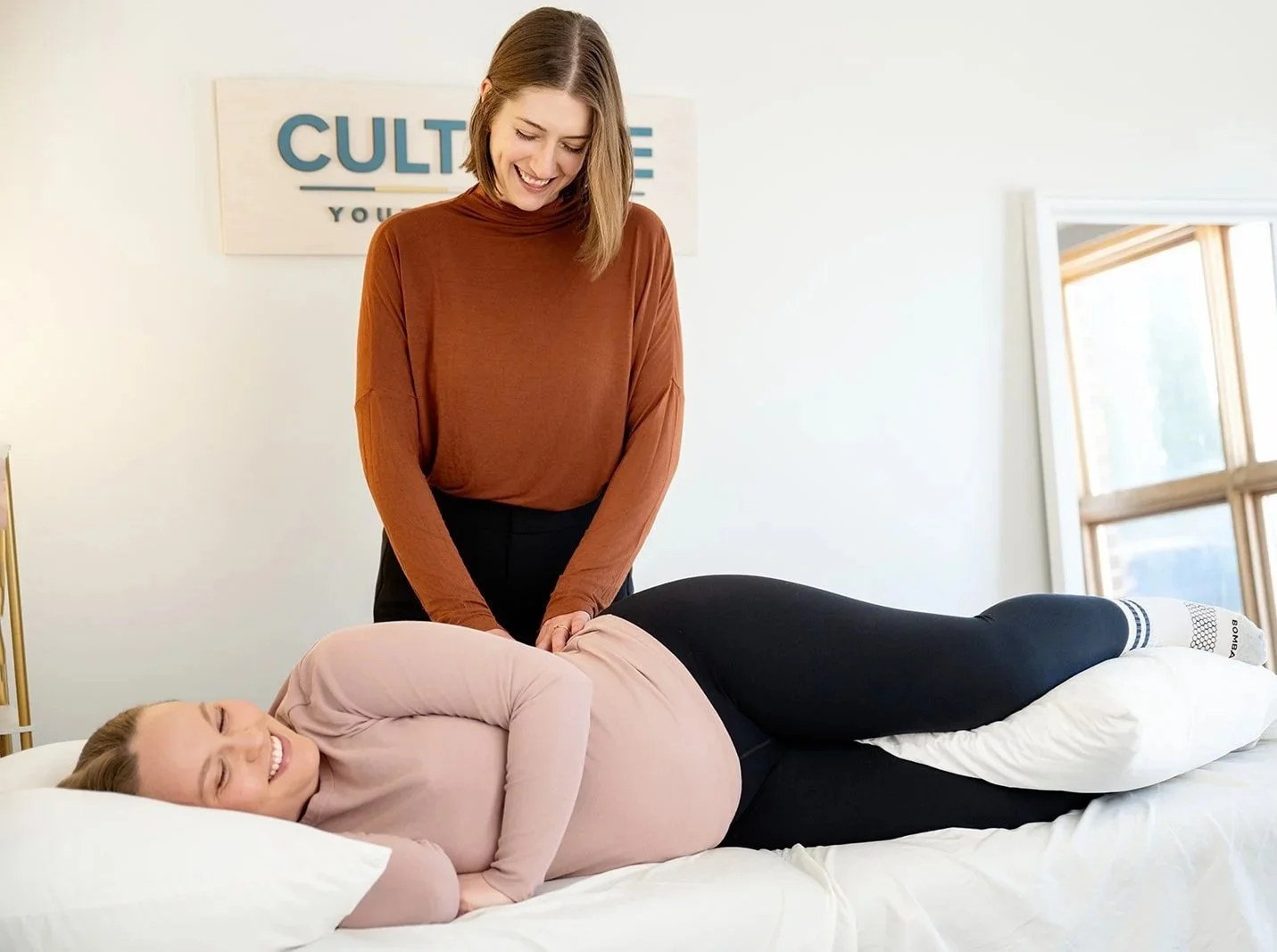 Pelvic health physical therapist providing hands-on care for a pregnant patient with pelvic pain at Cultivate Your Wellbeing, serving Mequon and Brookfield, Wisconsin.