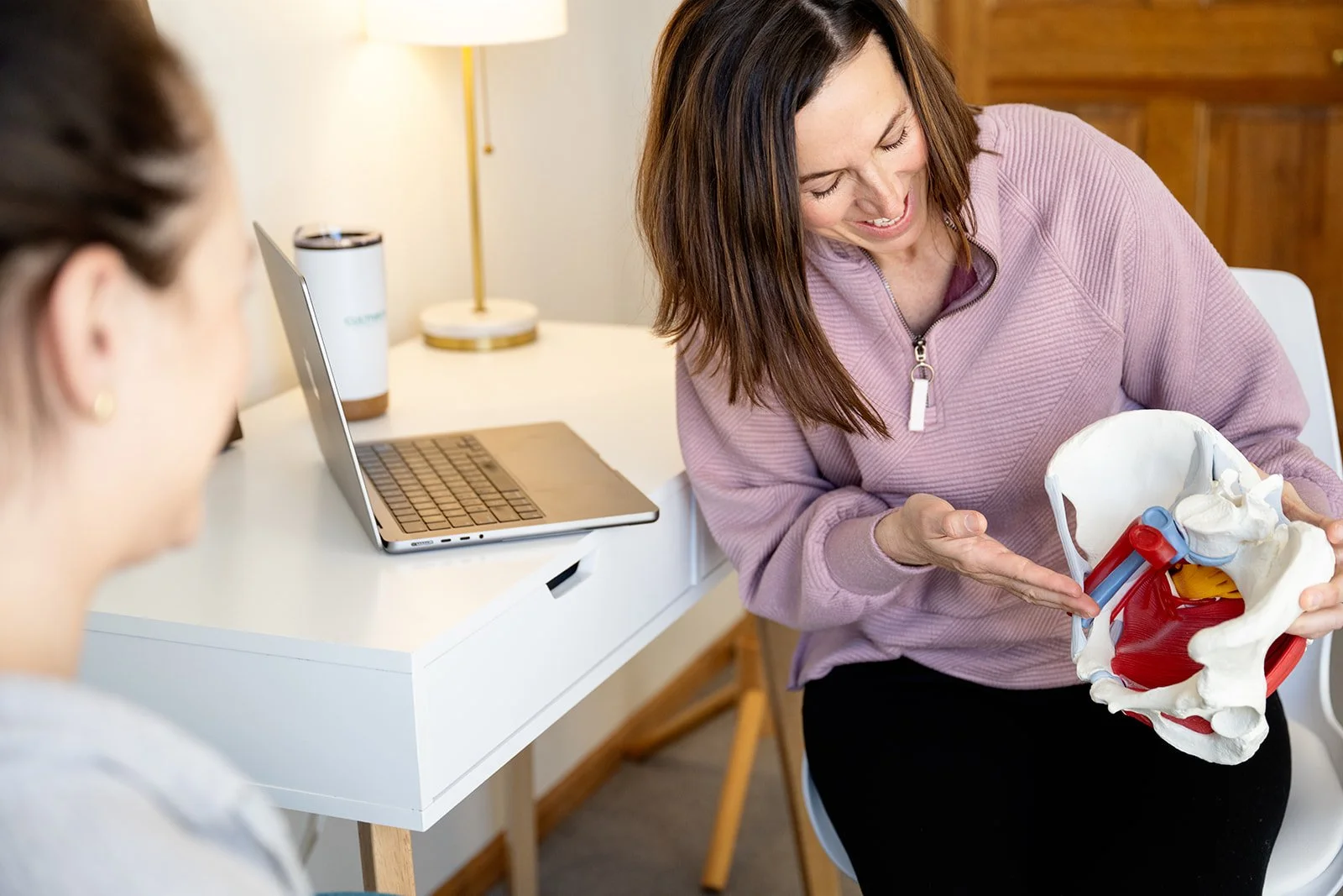 Pelvic health specialist Katie Tredo at Cultivate Your Wellbeing educating a patient with pelvic pain.
