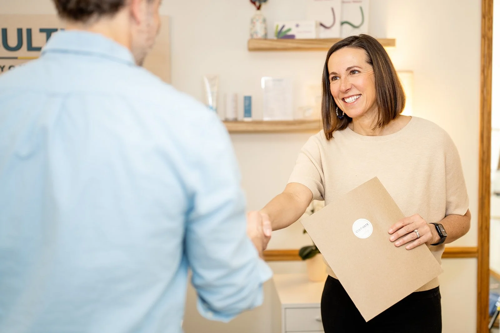 Pelvic health physical therapist welcoming a male patient for prostate support and pelvic floor physical therapy at Cultivate Your Wellbeing, serving Mequon and Brookfield, Wisconsin.