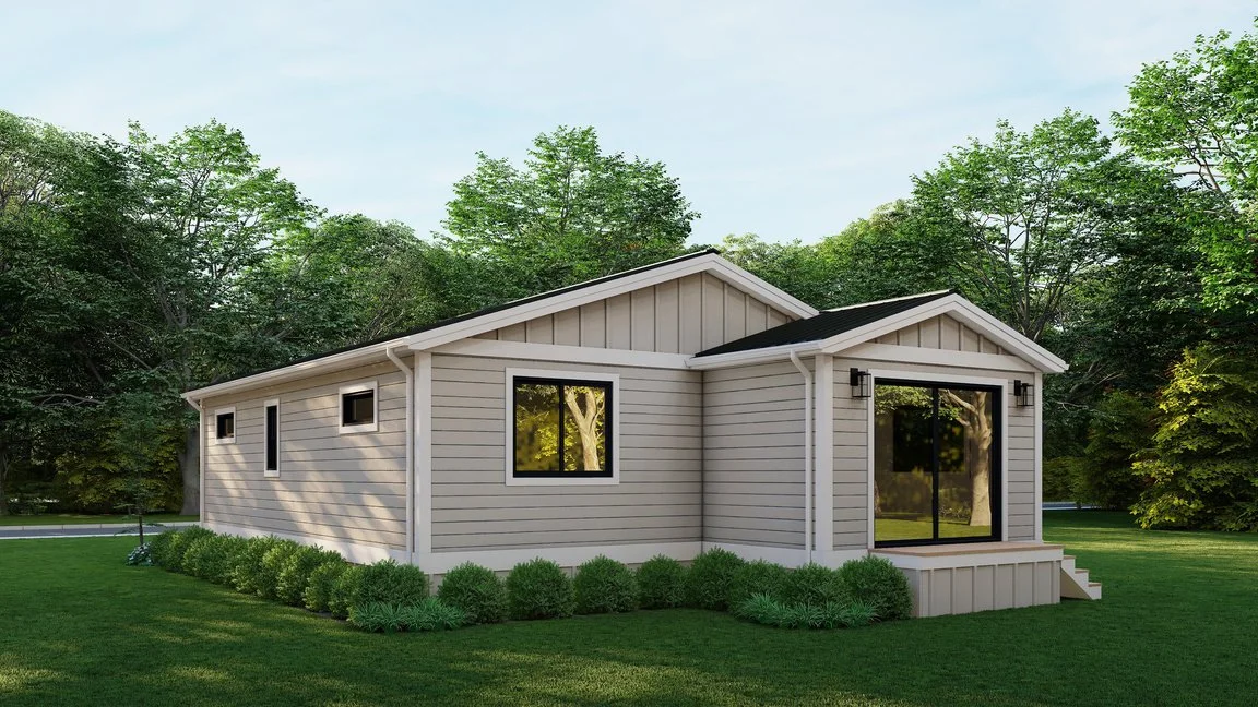A modern single-story house with beige siding, black window frames, sliding glass door, small front porch with steps, surrounded by green grass and trees in the background.